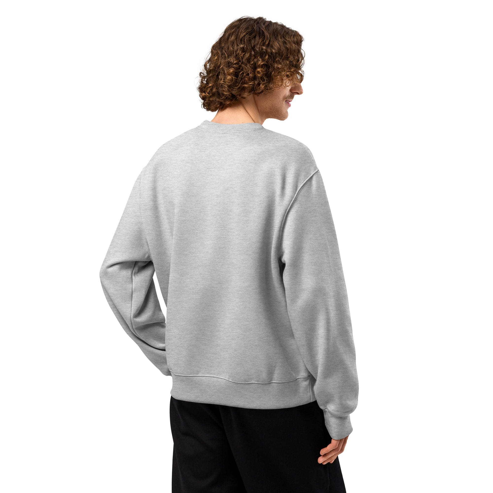 Person in gray sweatshirt facing away, smiling.