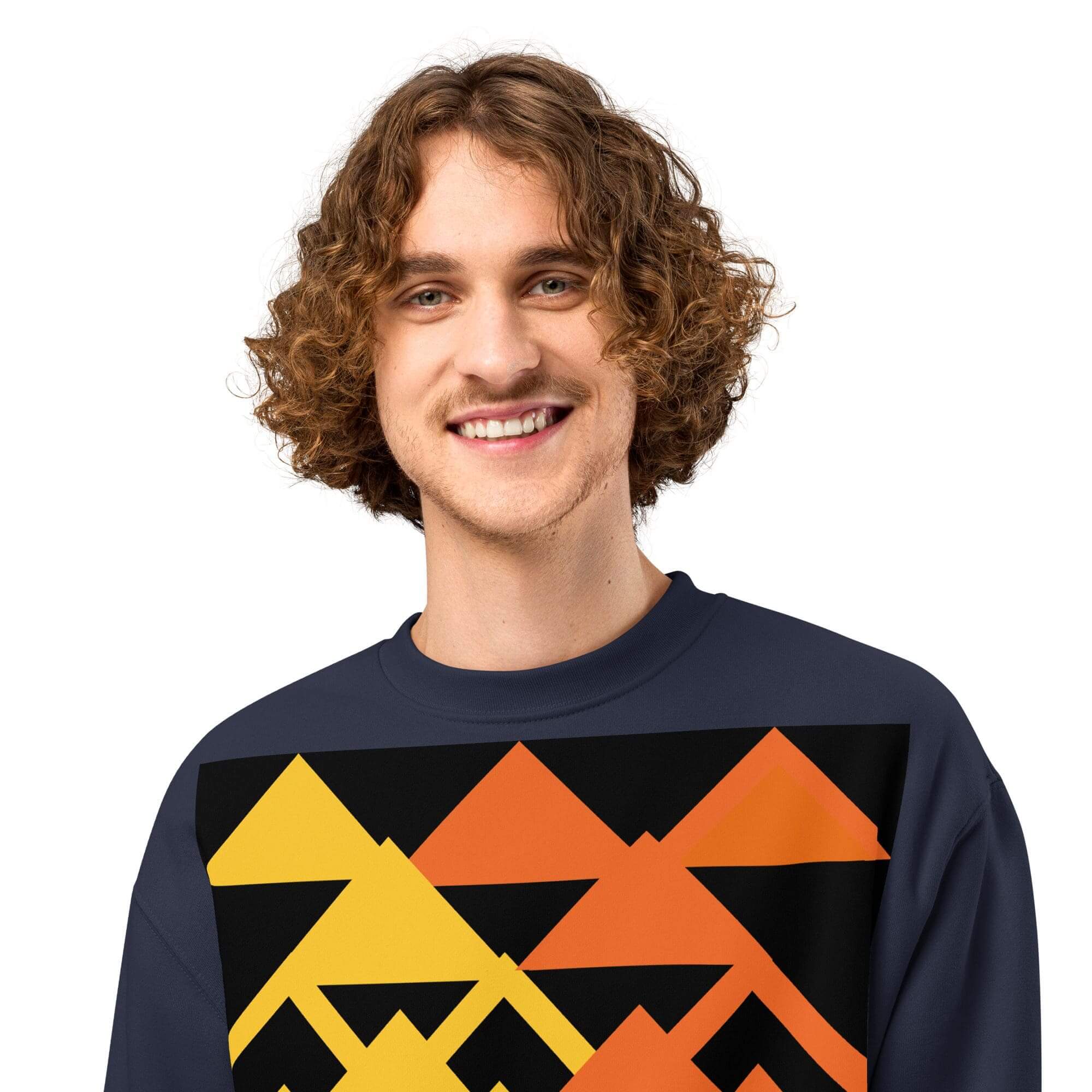 Smiling person wearing geometric patterned sweater.