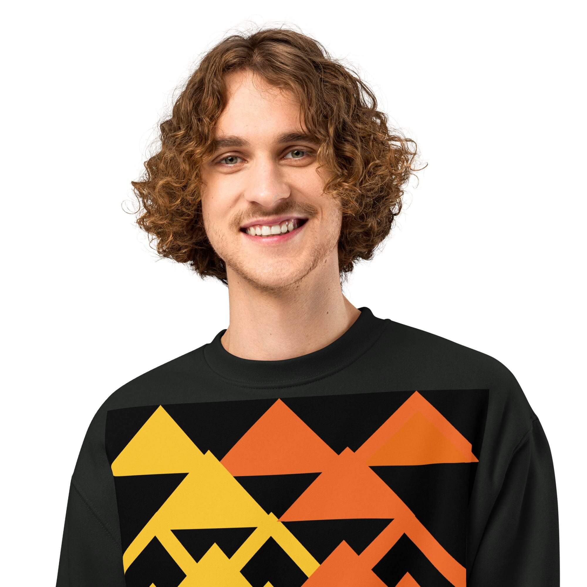 Smiling person wearing geometric-patterned sweater.