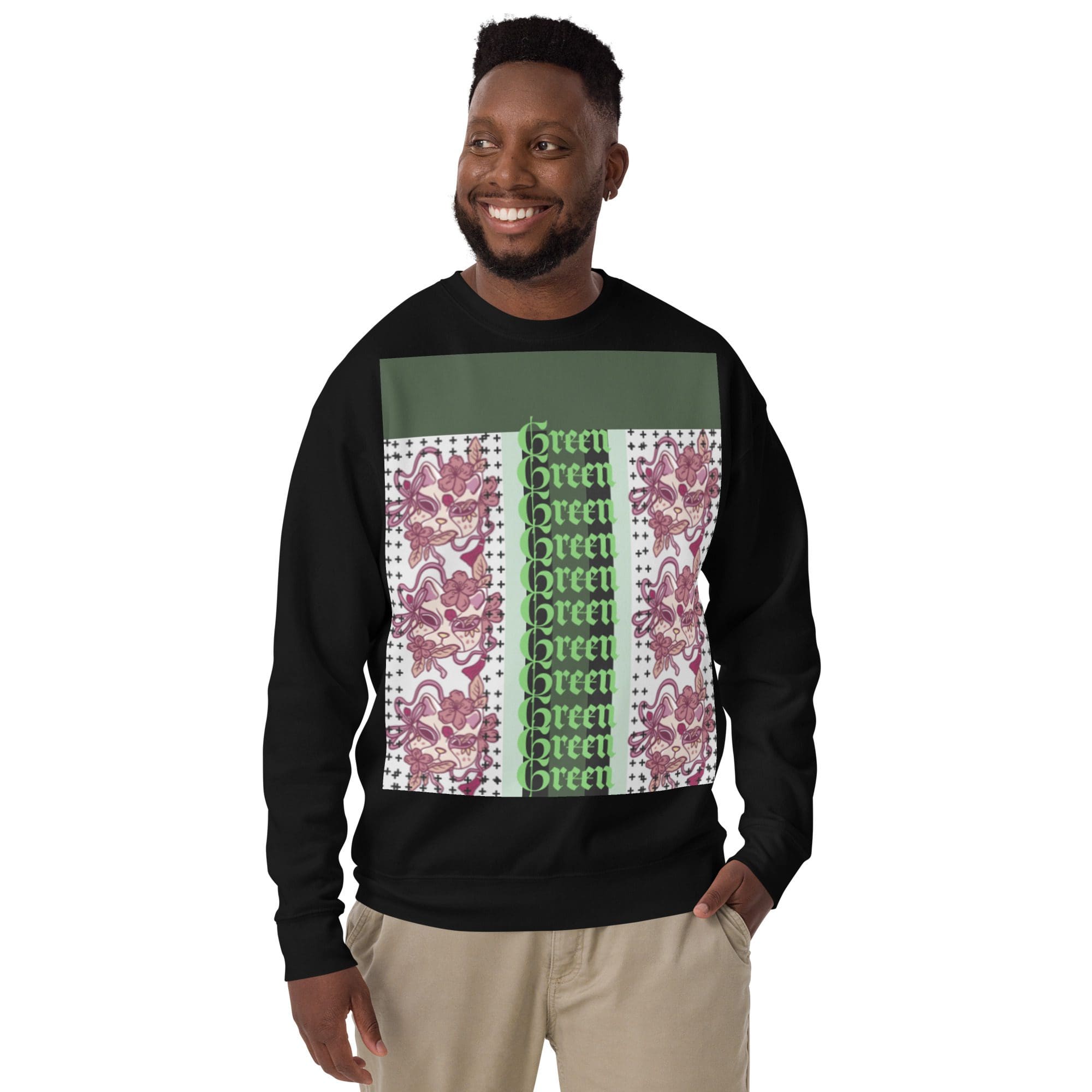 Man wearing patterned black sweatshirt, smiling.