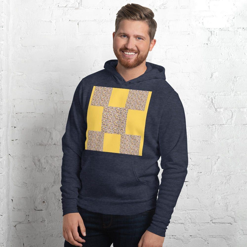Man wearing a patterned hoodie, smiling.