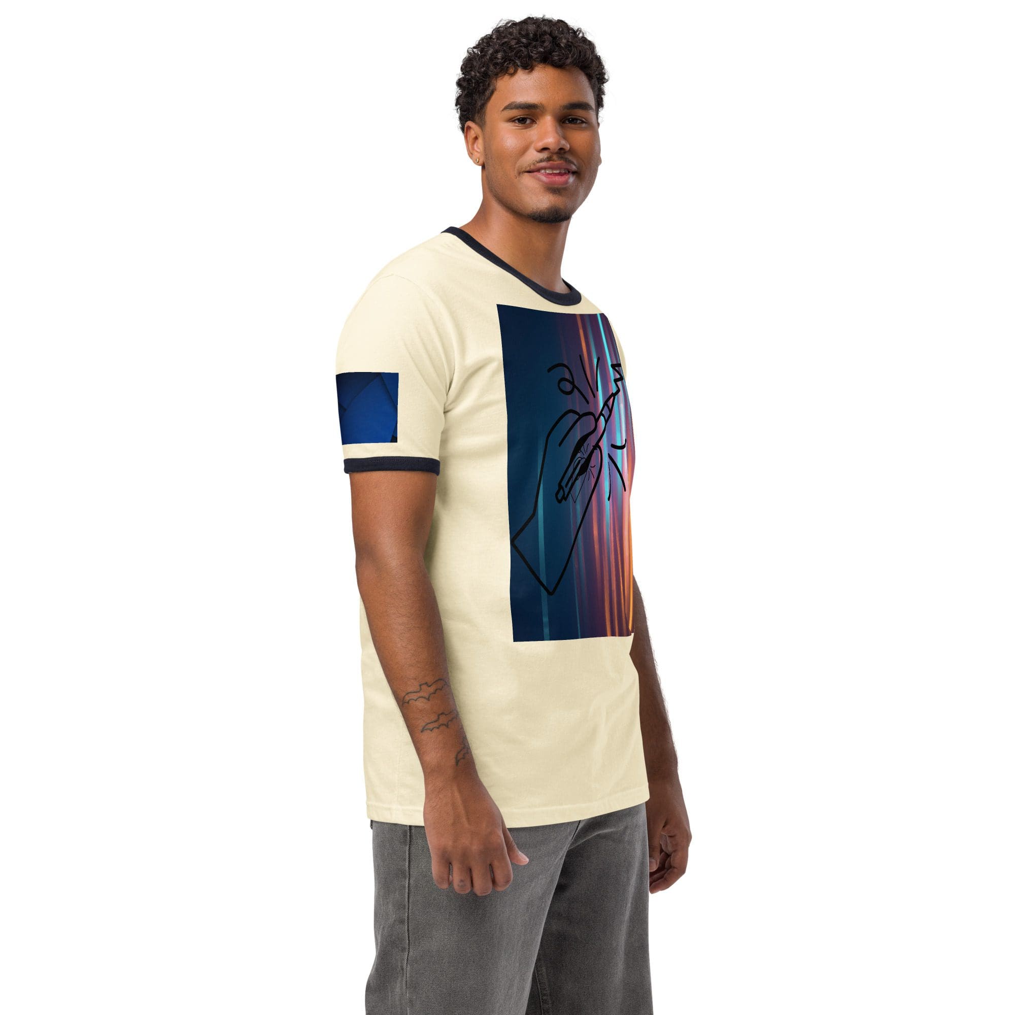 Man in graphic t-shirt and jeans smiling.