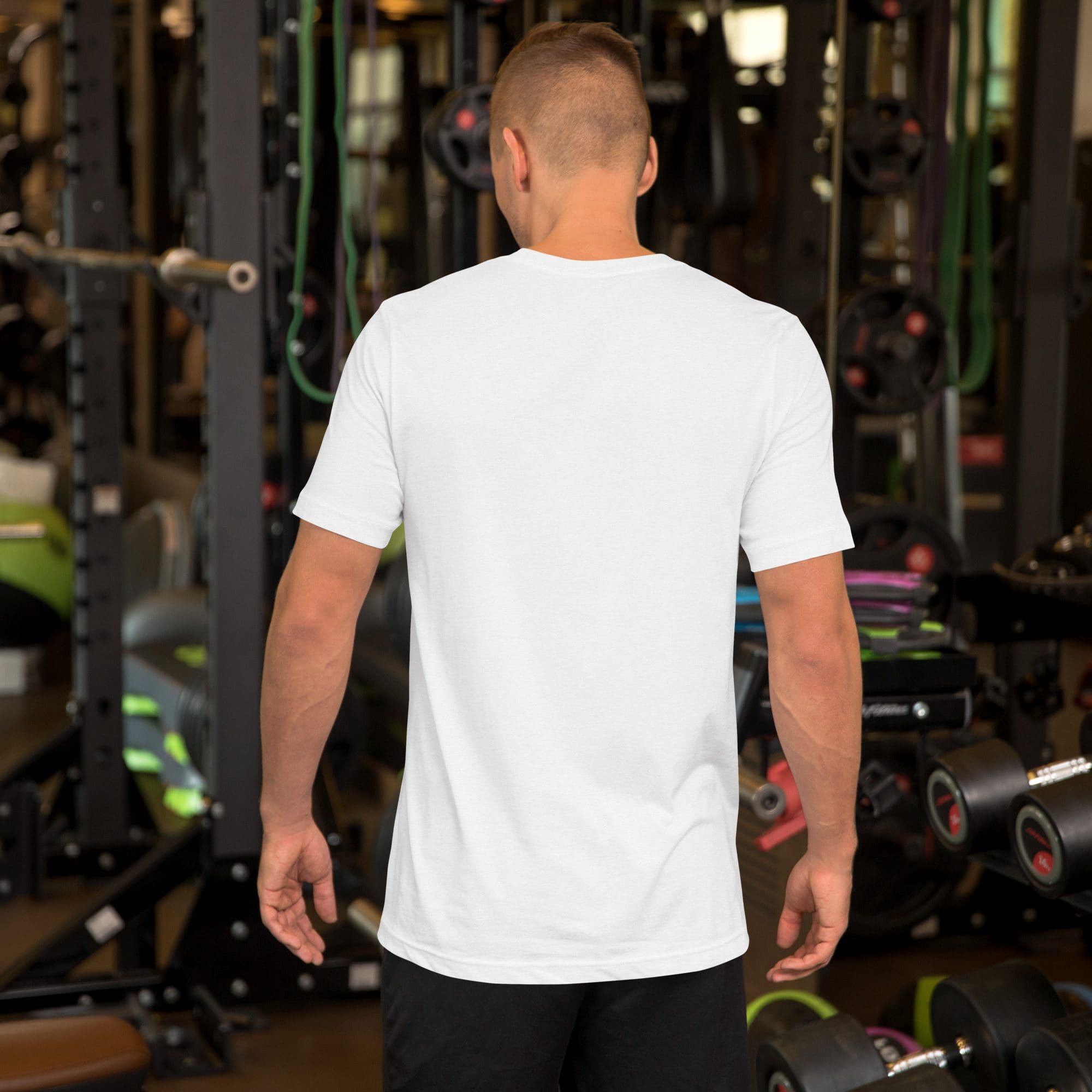 Man in gym wearing white t-shirt.