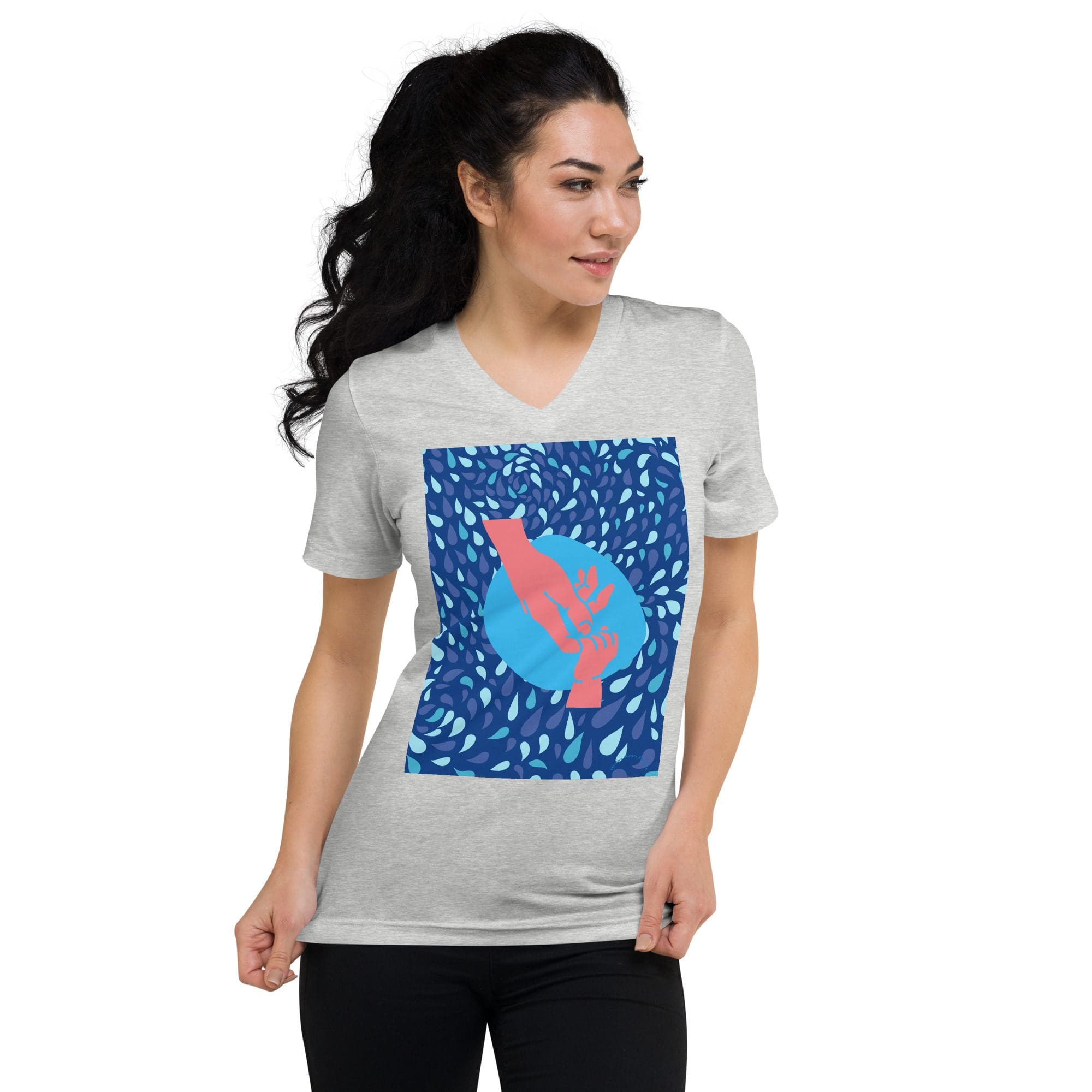 Woman wearing gray shirt with abstract design.