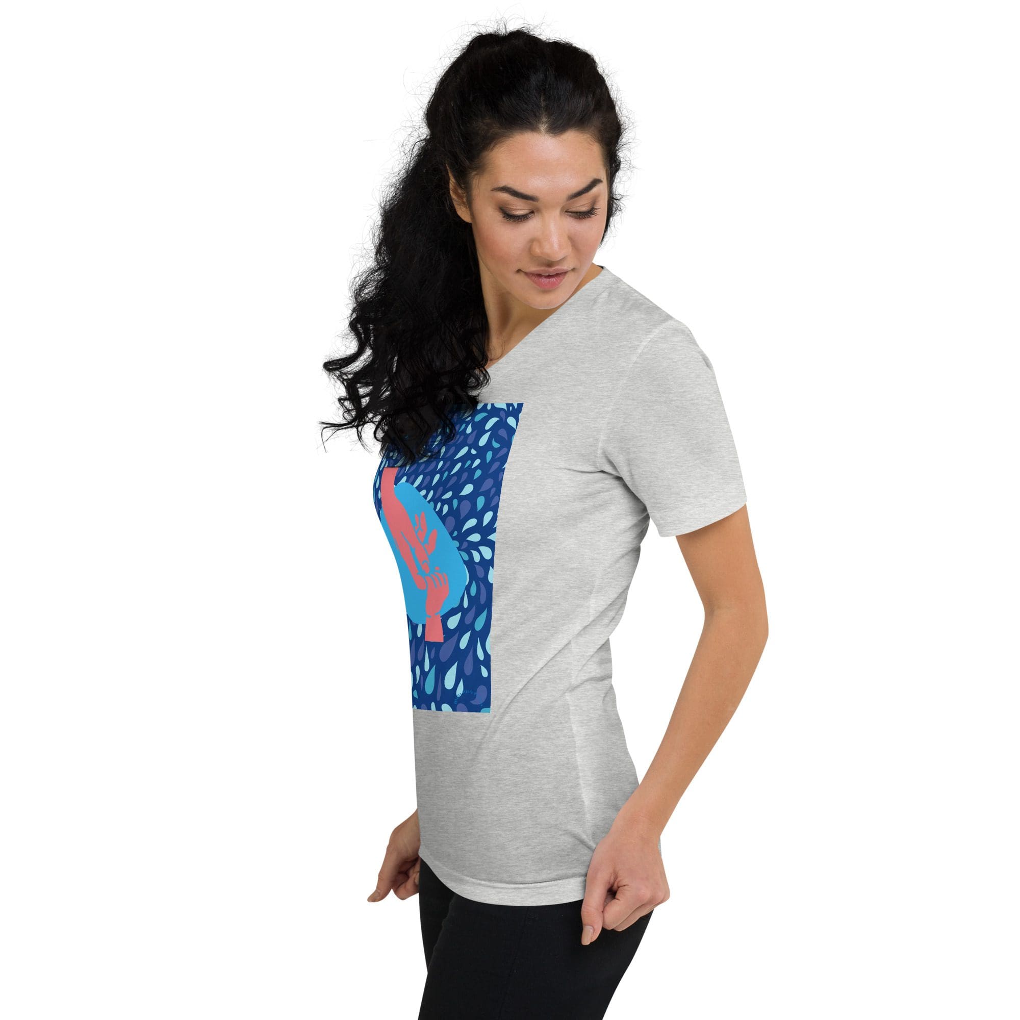 Woman in graphic t-shirt, looking down.