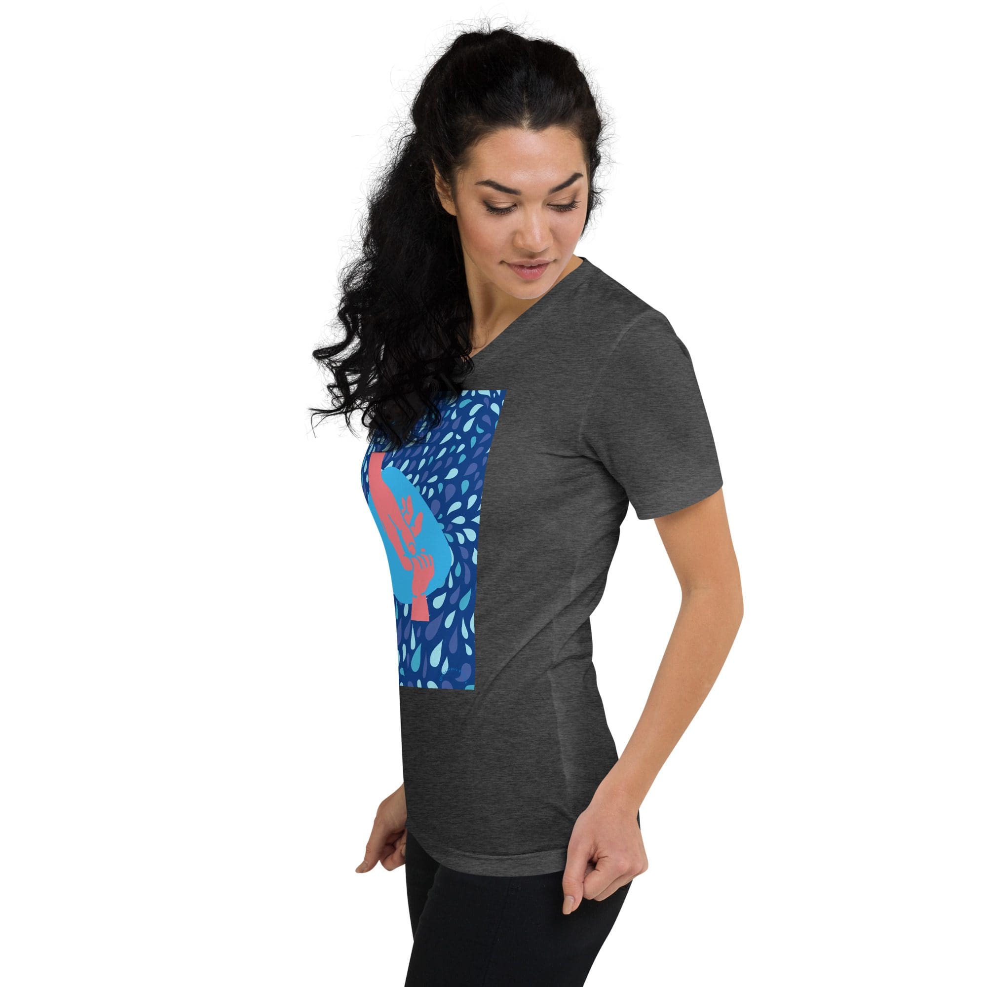 Woman wearing dark graphic t-shirt, looking down.