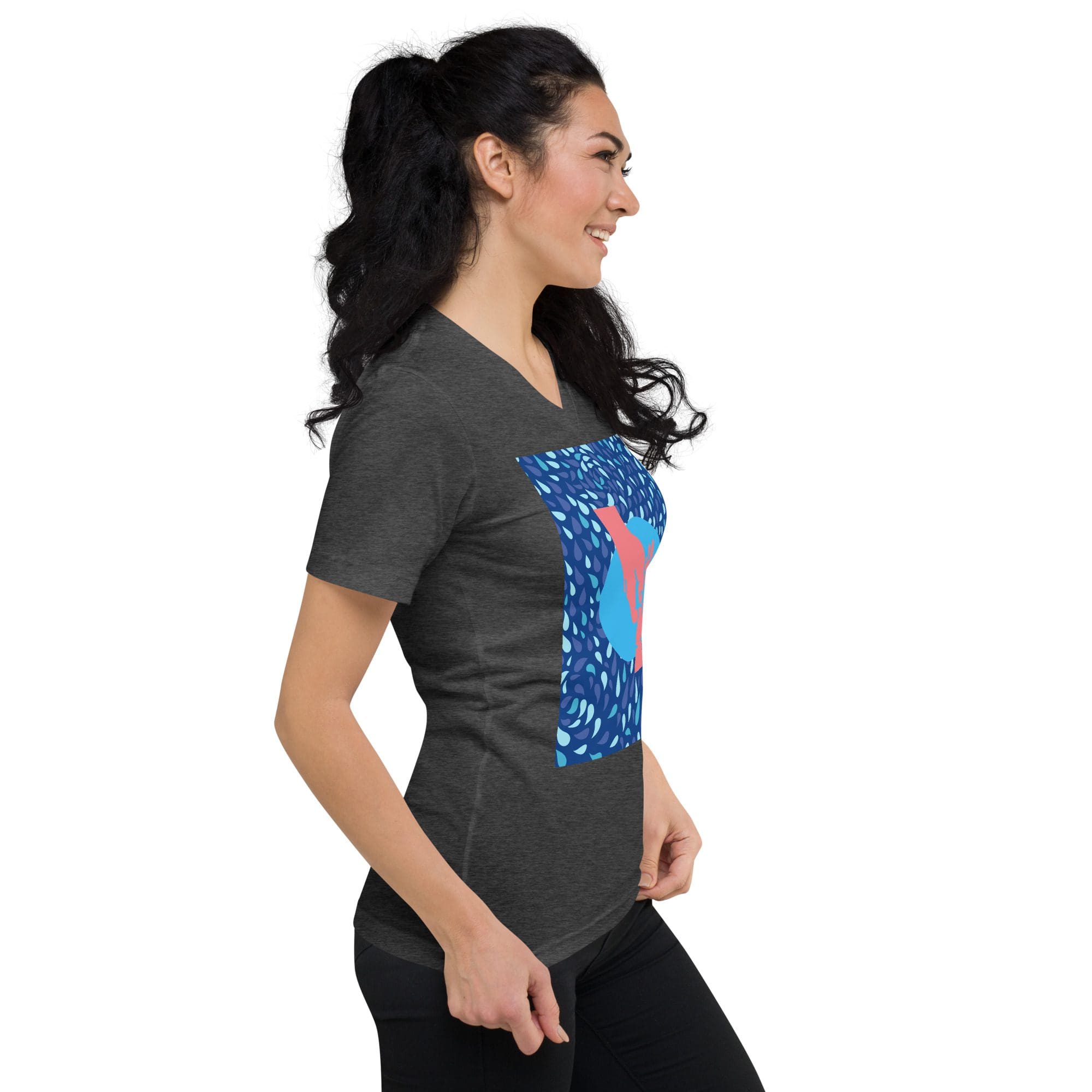 Woman wearing graphic t-shirt, smiling sideways.