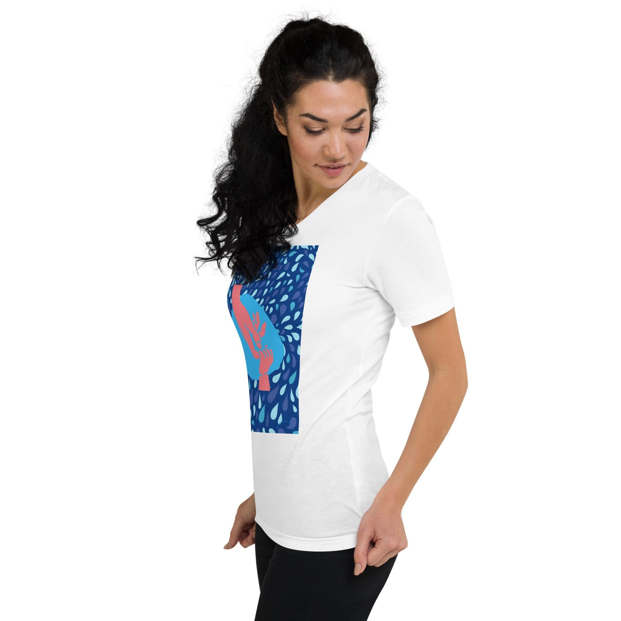 Woman wearing white graphic t-shirt, black pants.