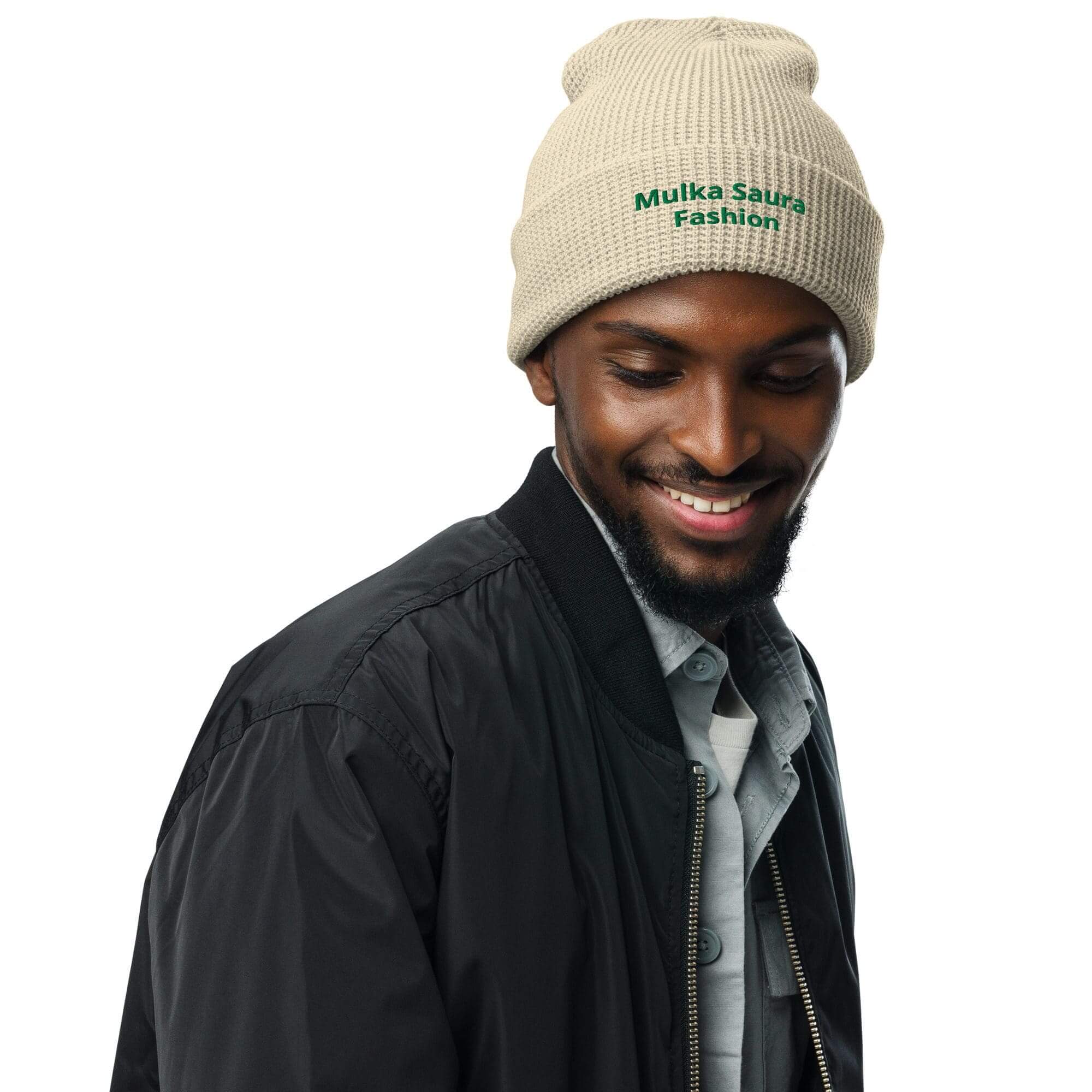 Man wearing beige beanie and black jacket.