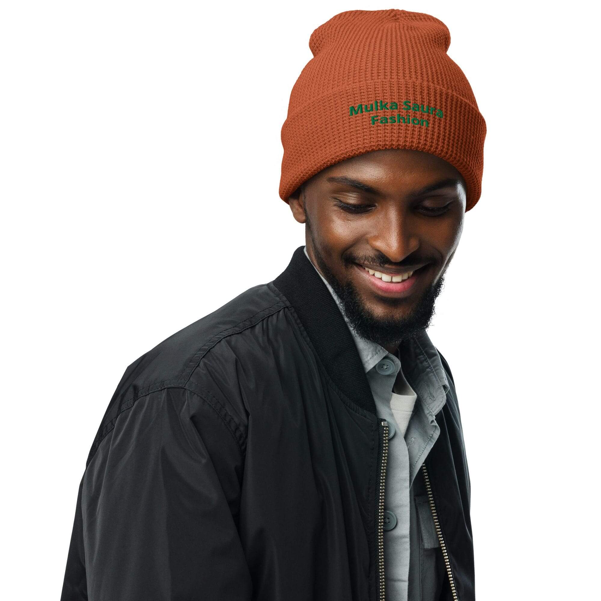 Smiling man wearing brown beanie and jacket.