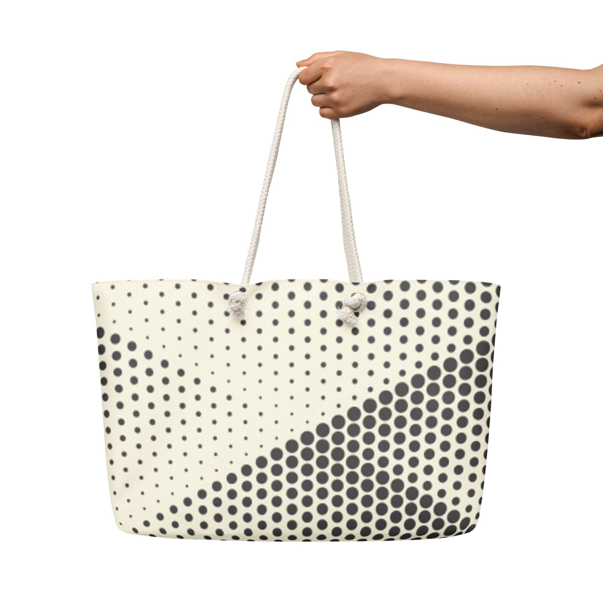 Polka dot tote bag held by hand.