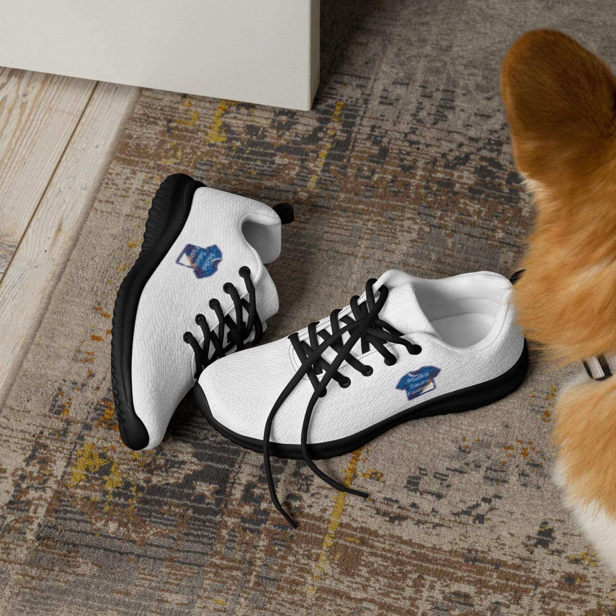 White sneakers with black laces on rug.