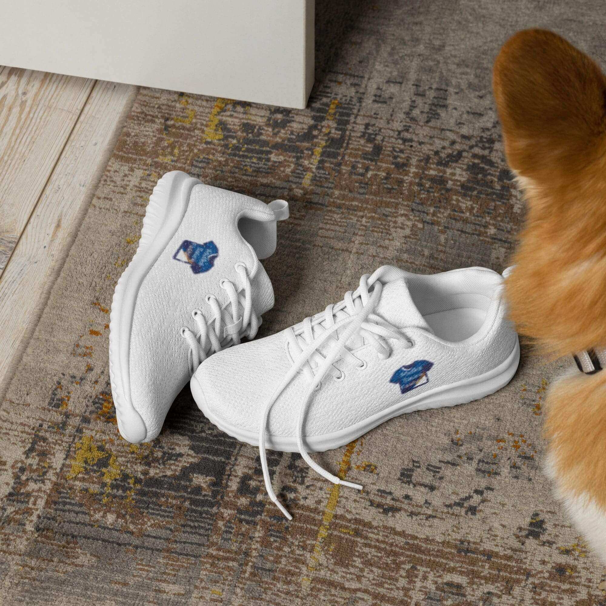 White sneakers on rug with dog nearby.