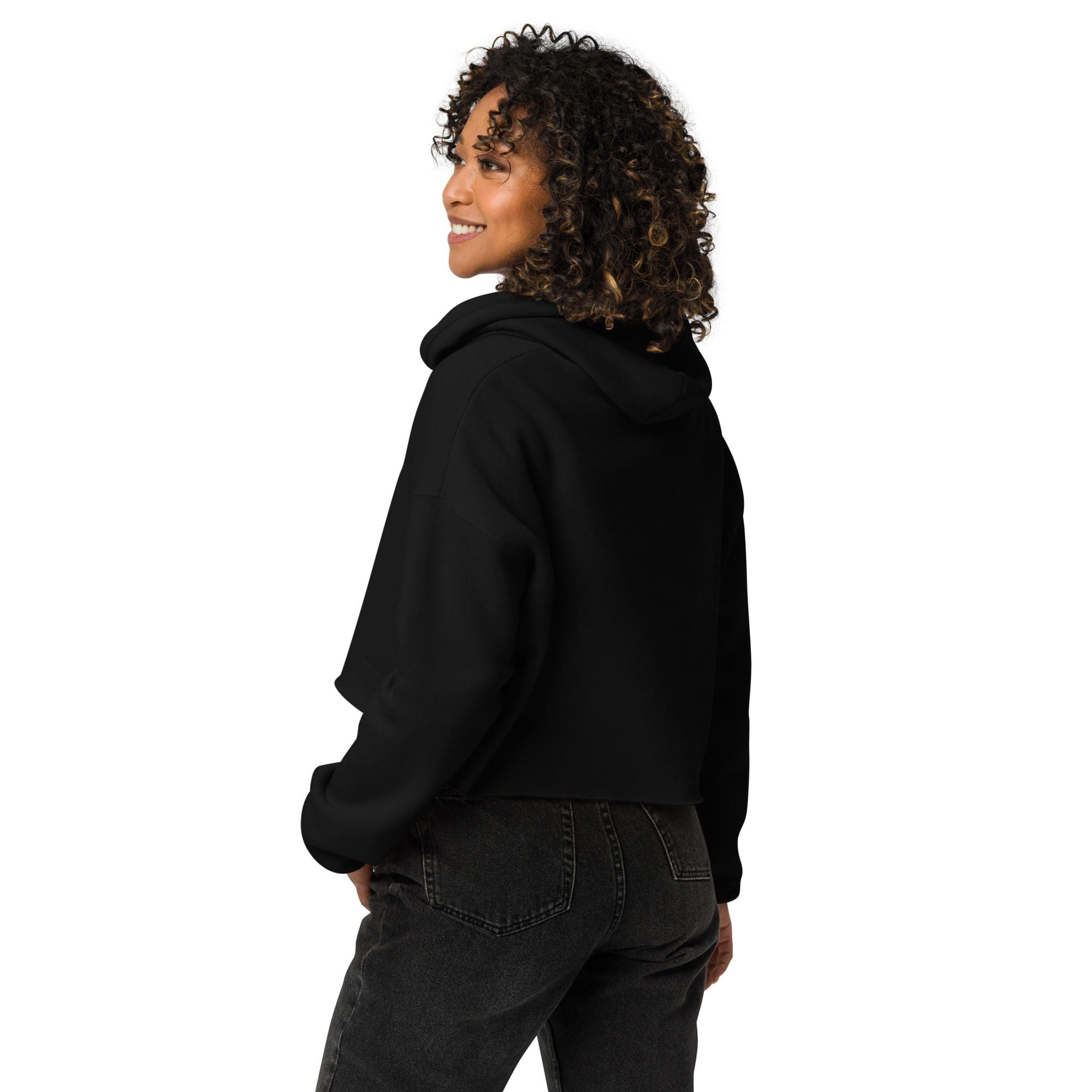 Smiling person in black hoodie and jeans.