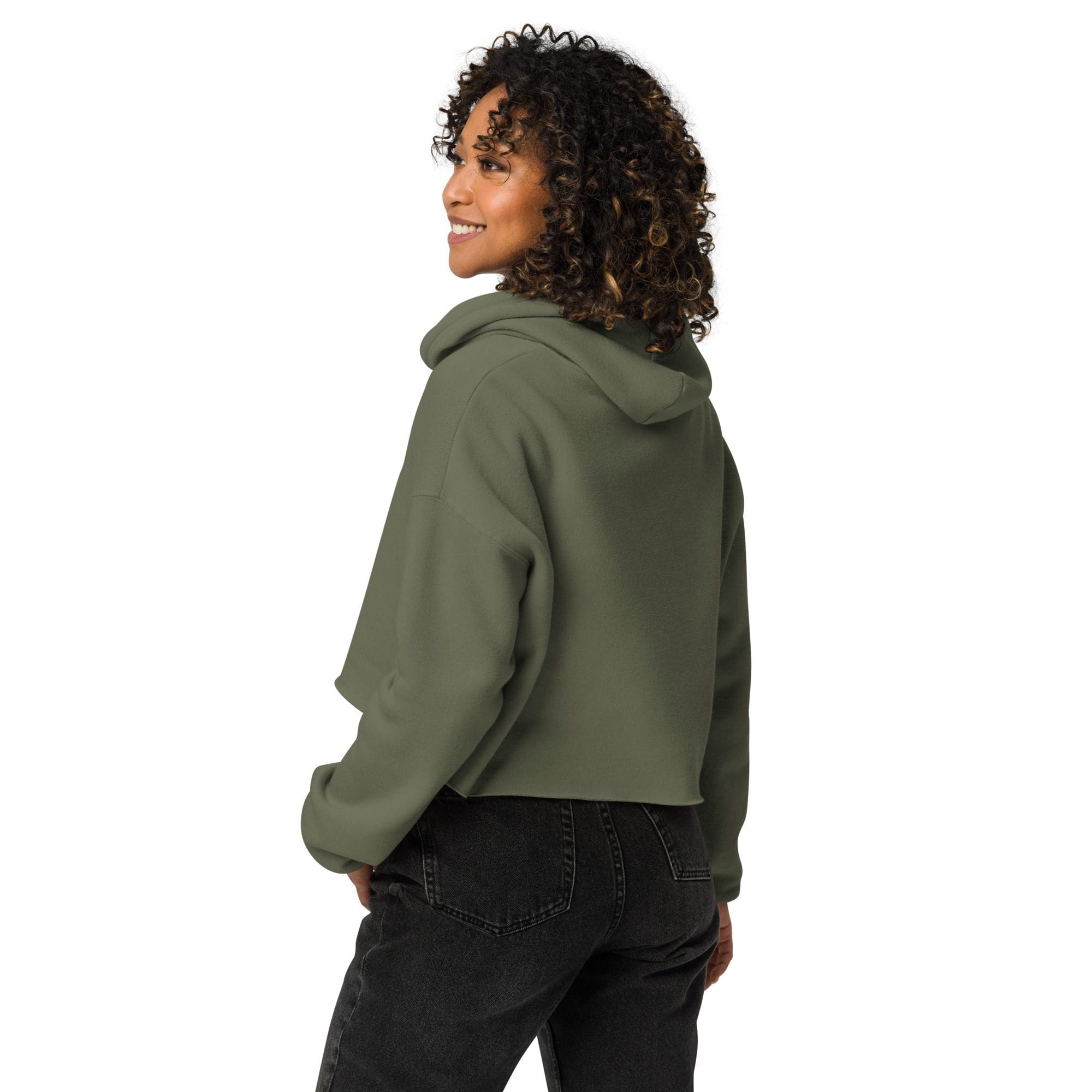 Woman in green hoodie, smiling, looking sideways.