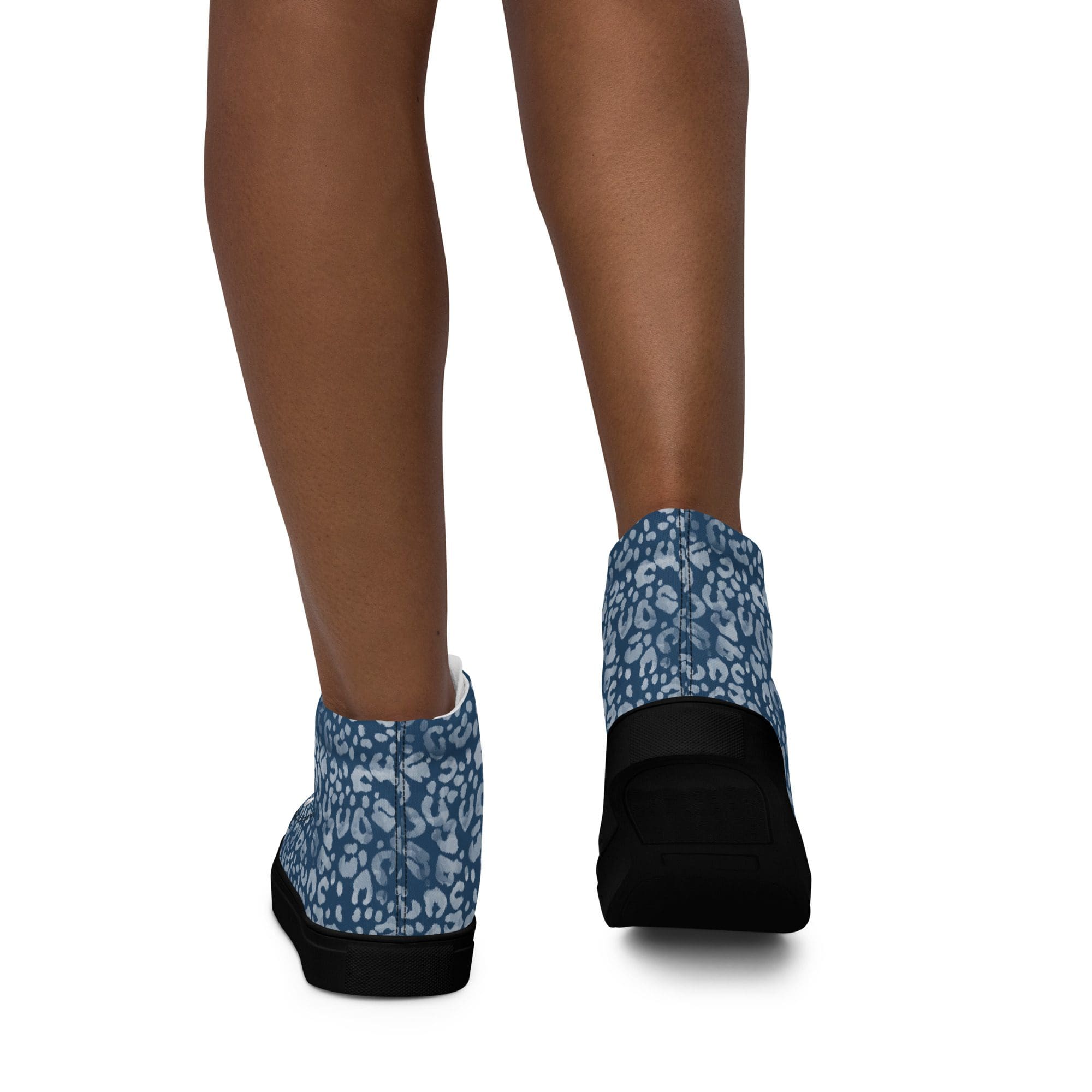 Blue patterned shoes on person's feet.