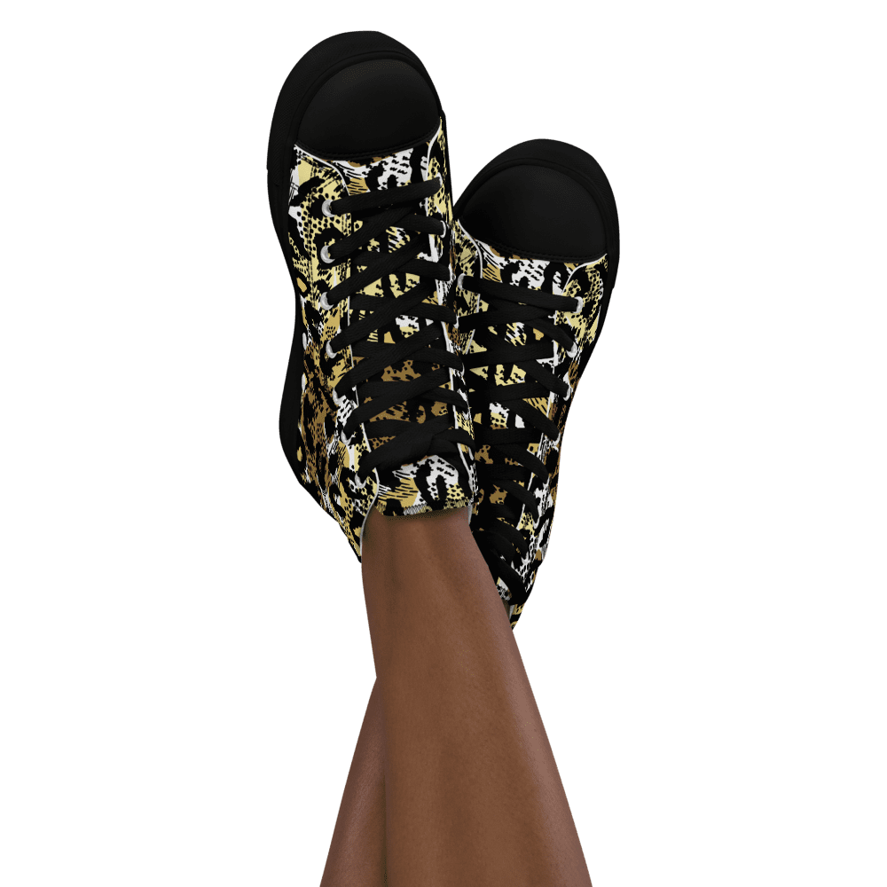 Legs wearing patterned sneakers on black background.