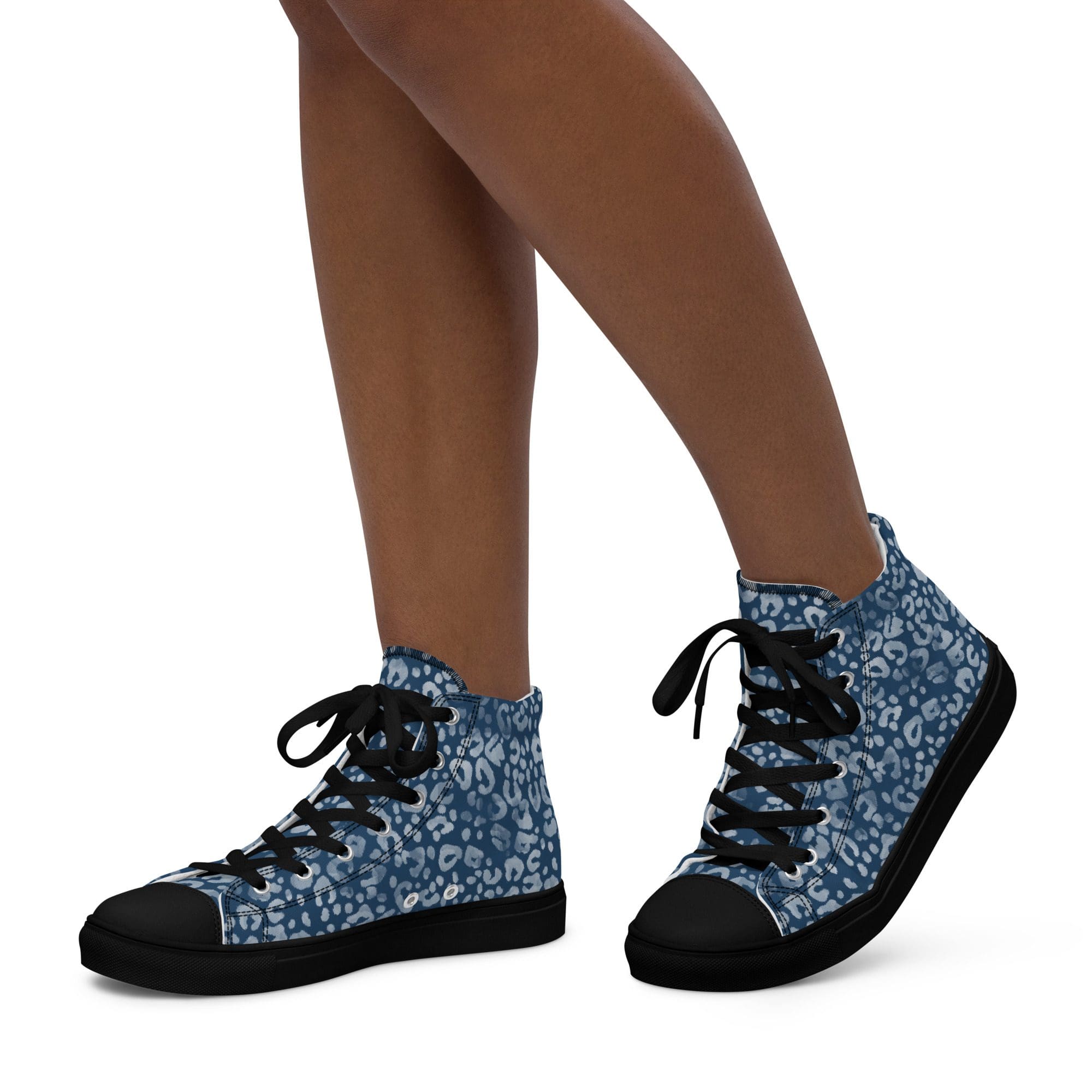Legs wearing blue leopard print sneakers.