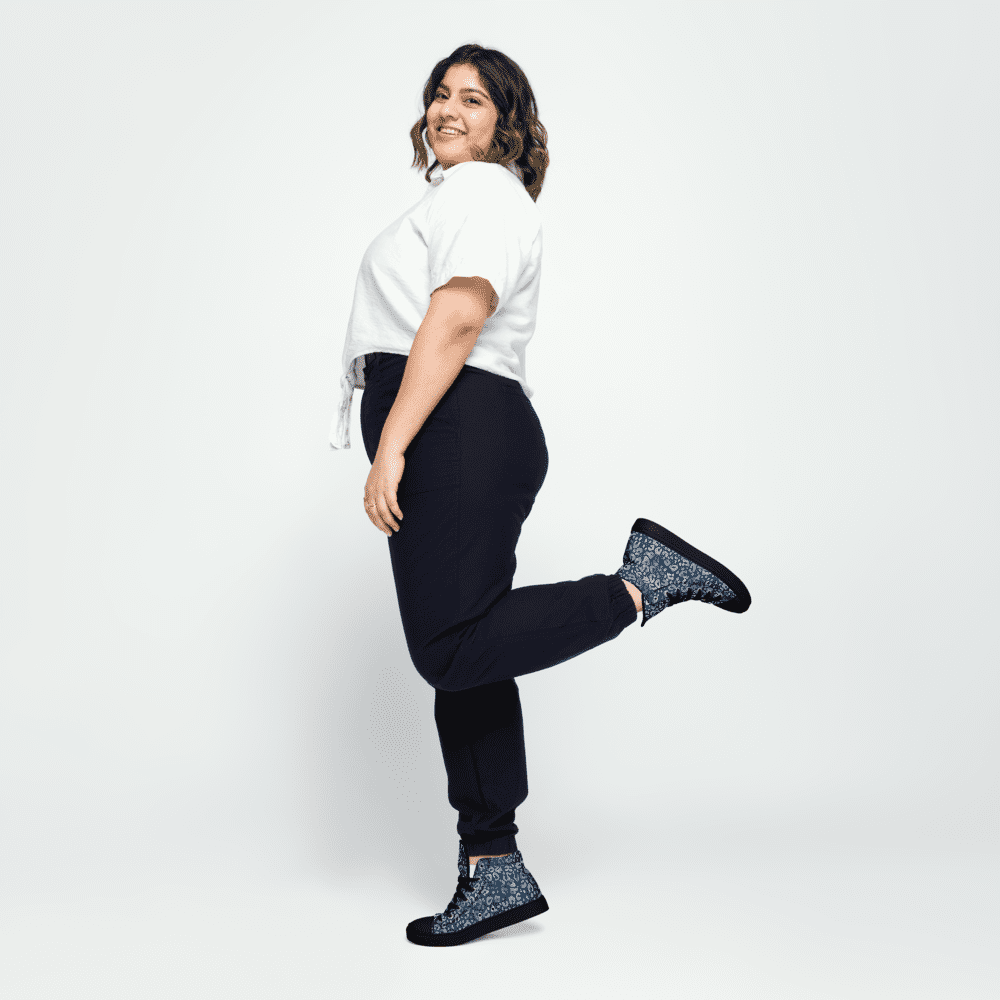 Smiling woman posing in casual outfit.