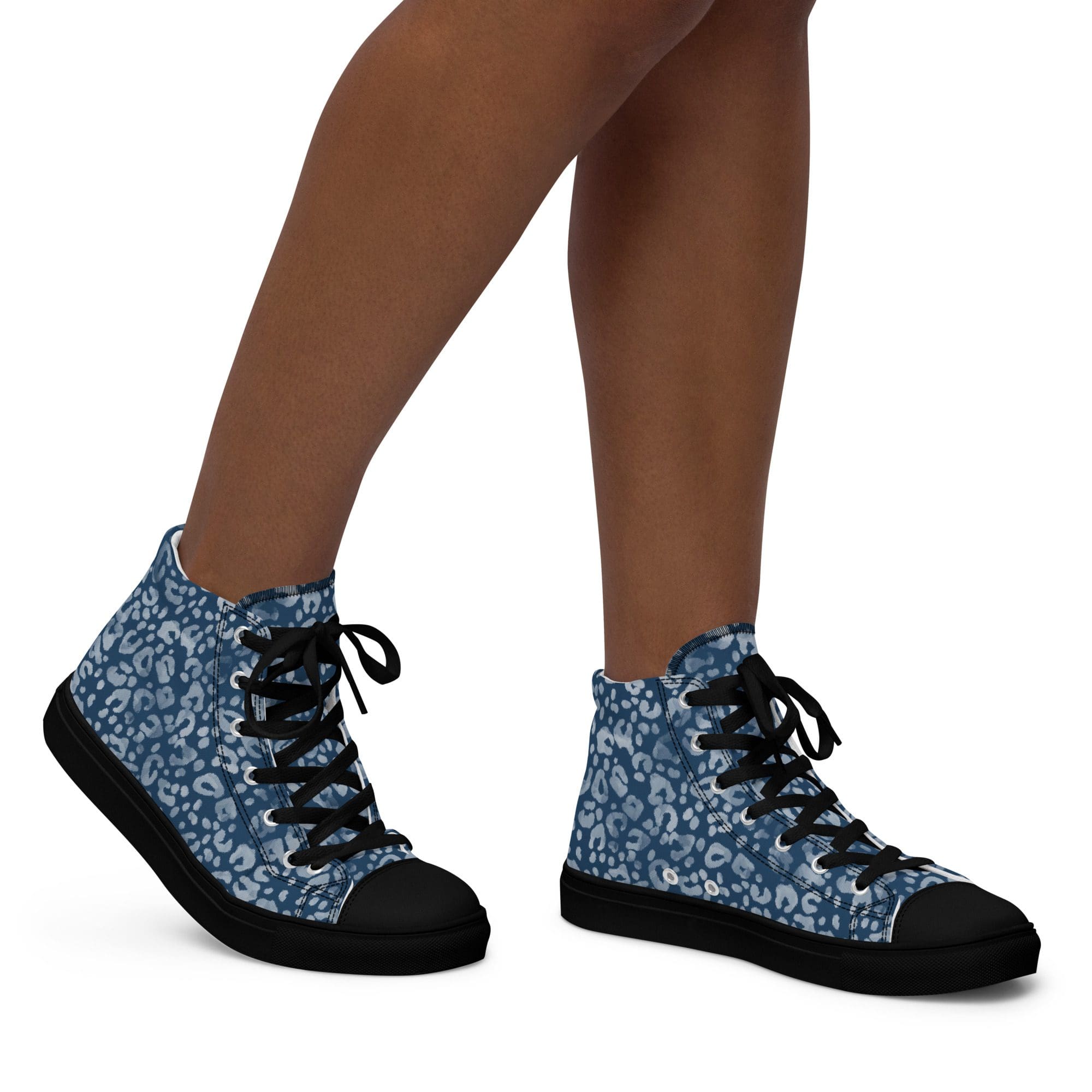Blue patterned sneakers on person's feet.