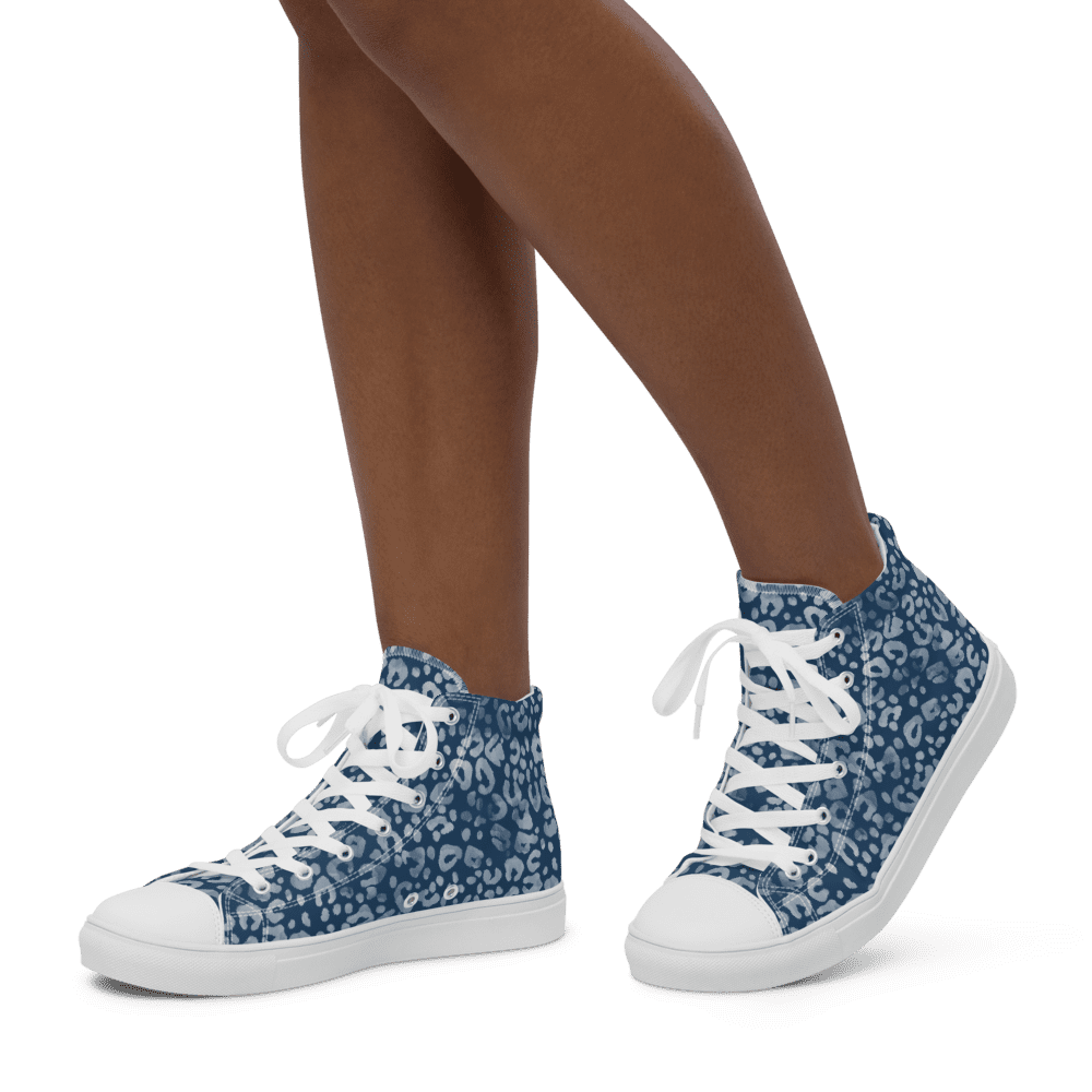 Person wearing blue patterned high-top sneakers.