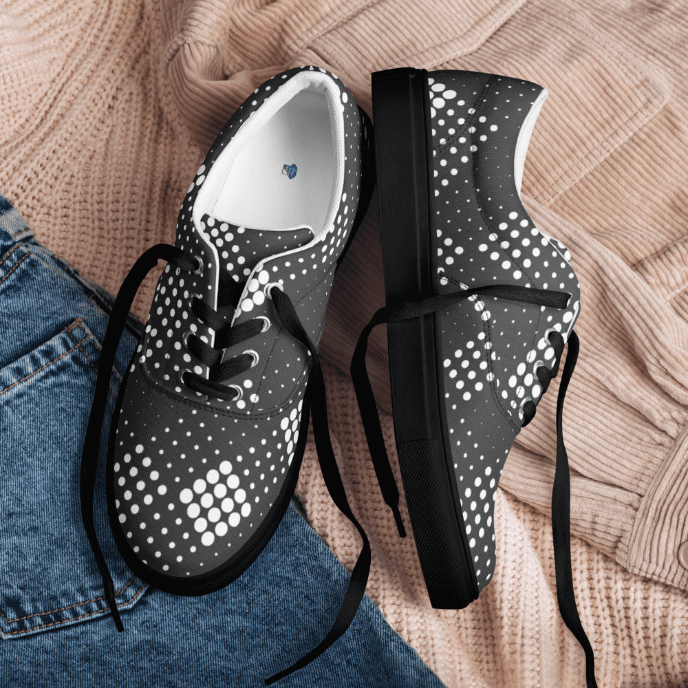 Black polka dot shoes on fabric background.