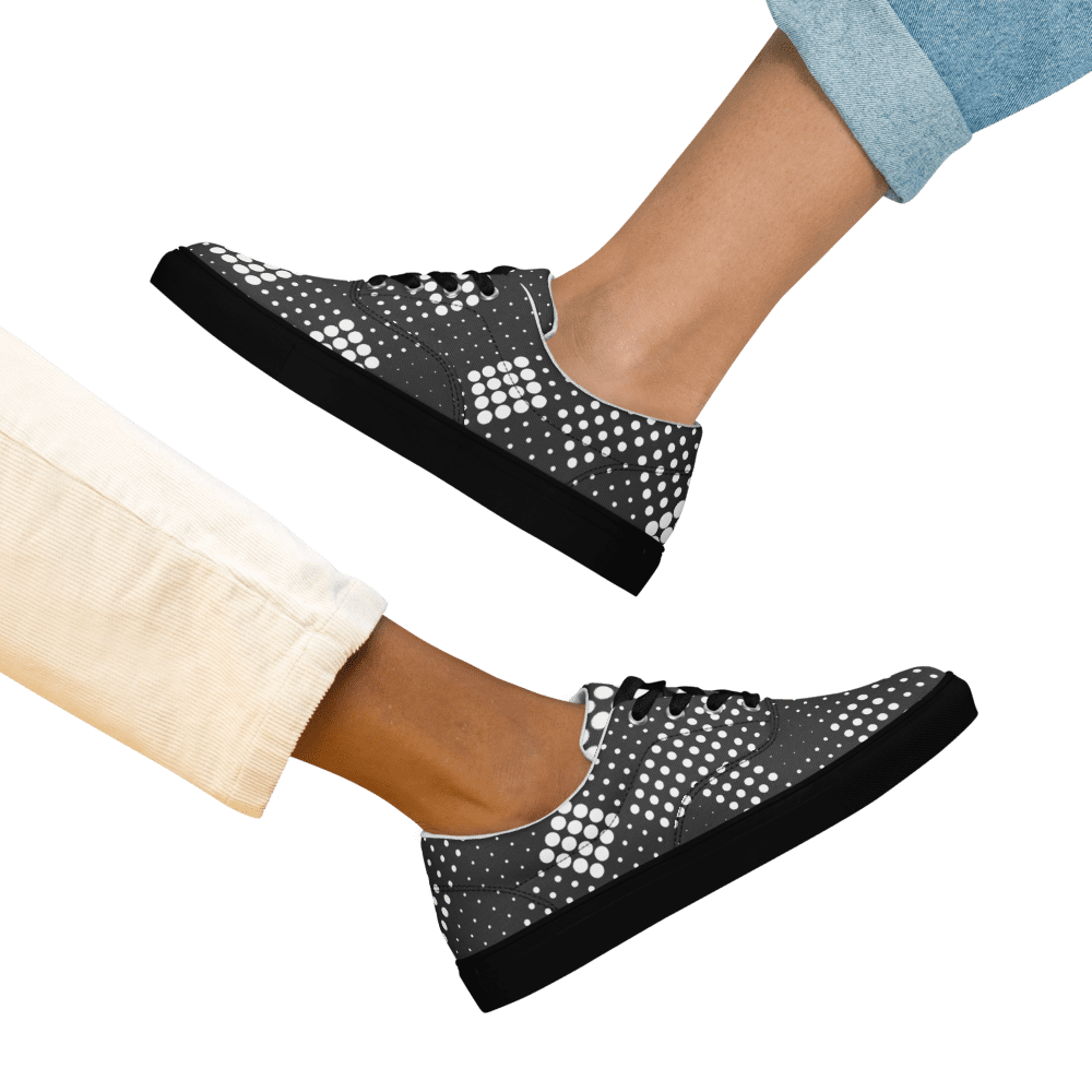 Two legs wearing stylish polka dot shoes.