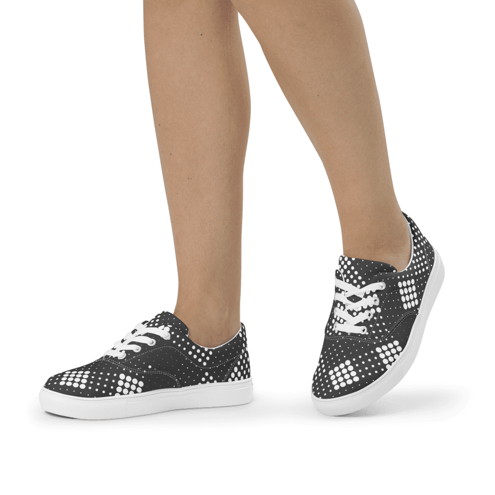 Legs wearing black polka-dot sneakers