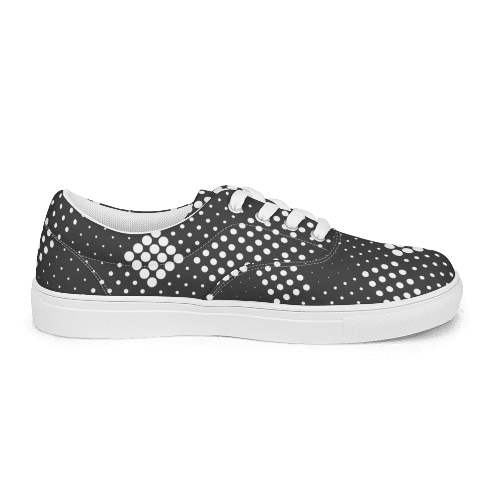 Black polka dot sneaker on black background.