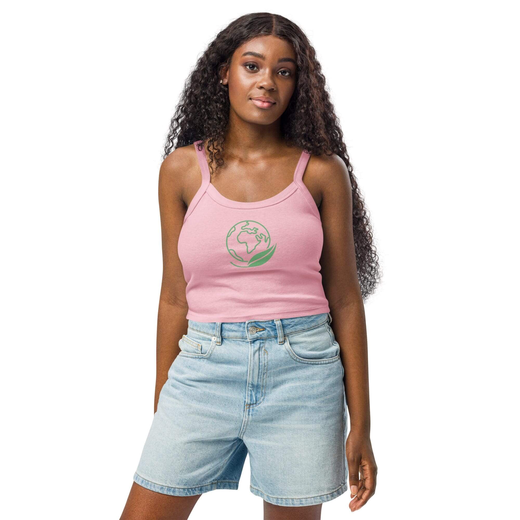 Woman in pink top and denim shorts.