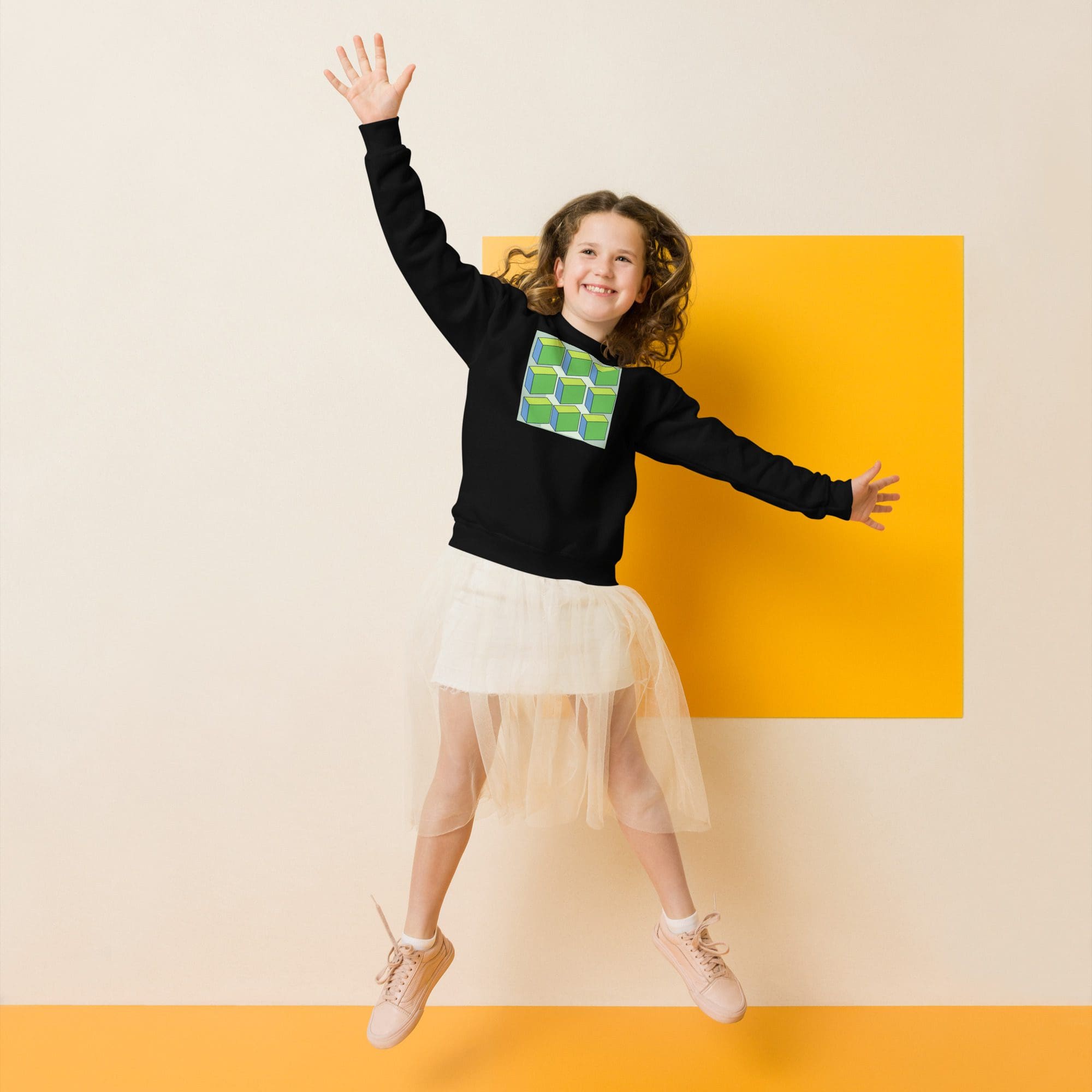 Child jumping joyfully in stylish outfit.