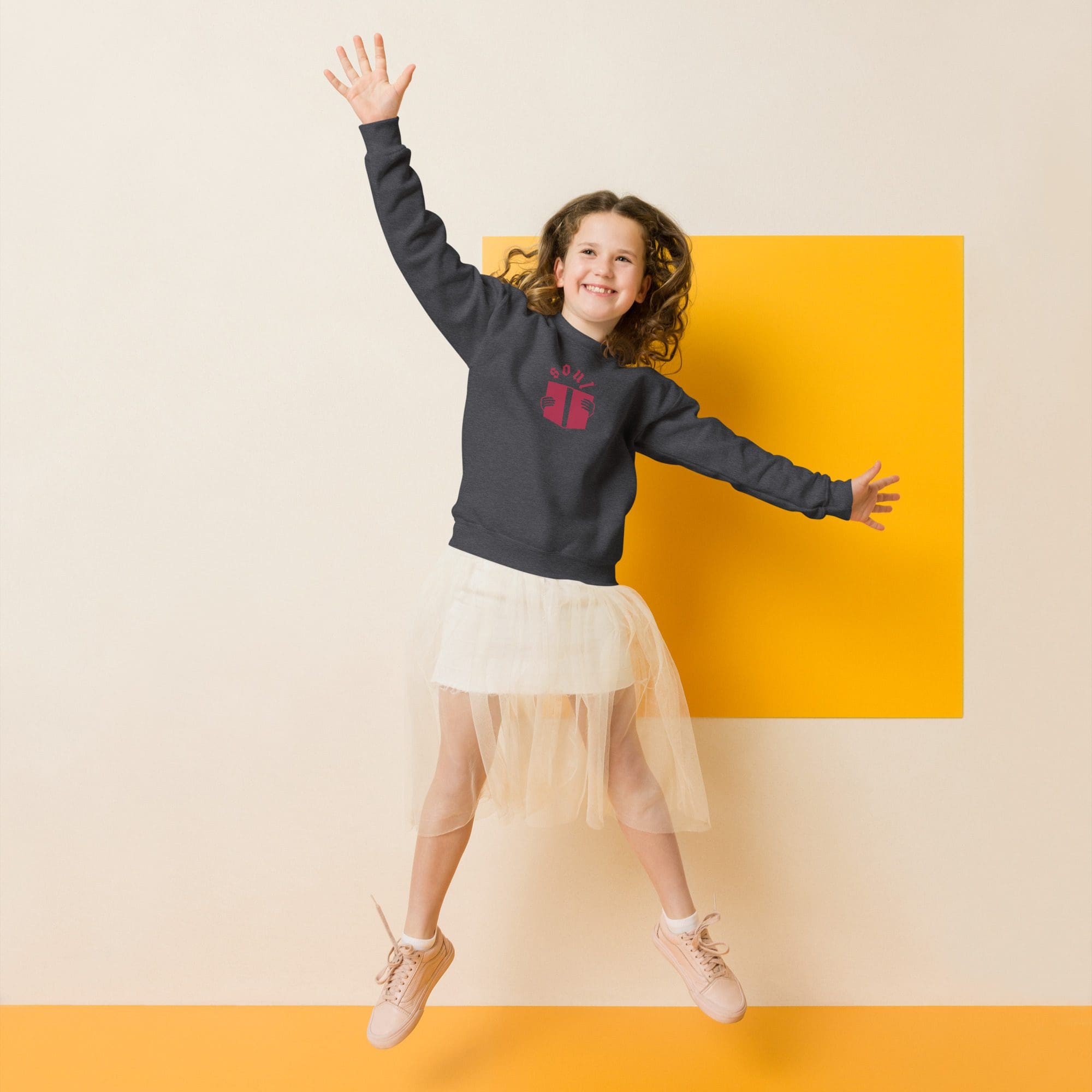 Smiling girl jumping in tulle skirt