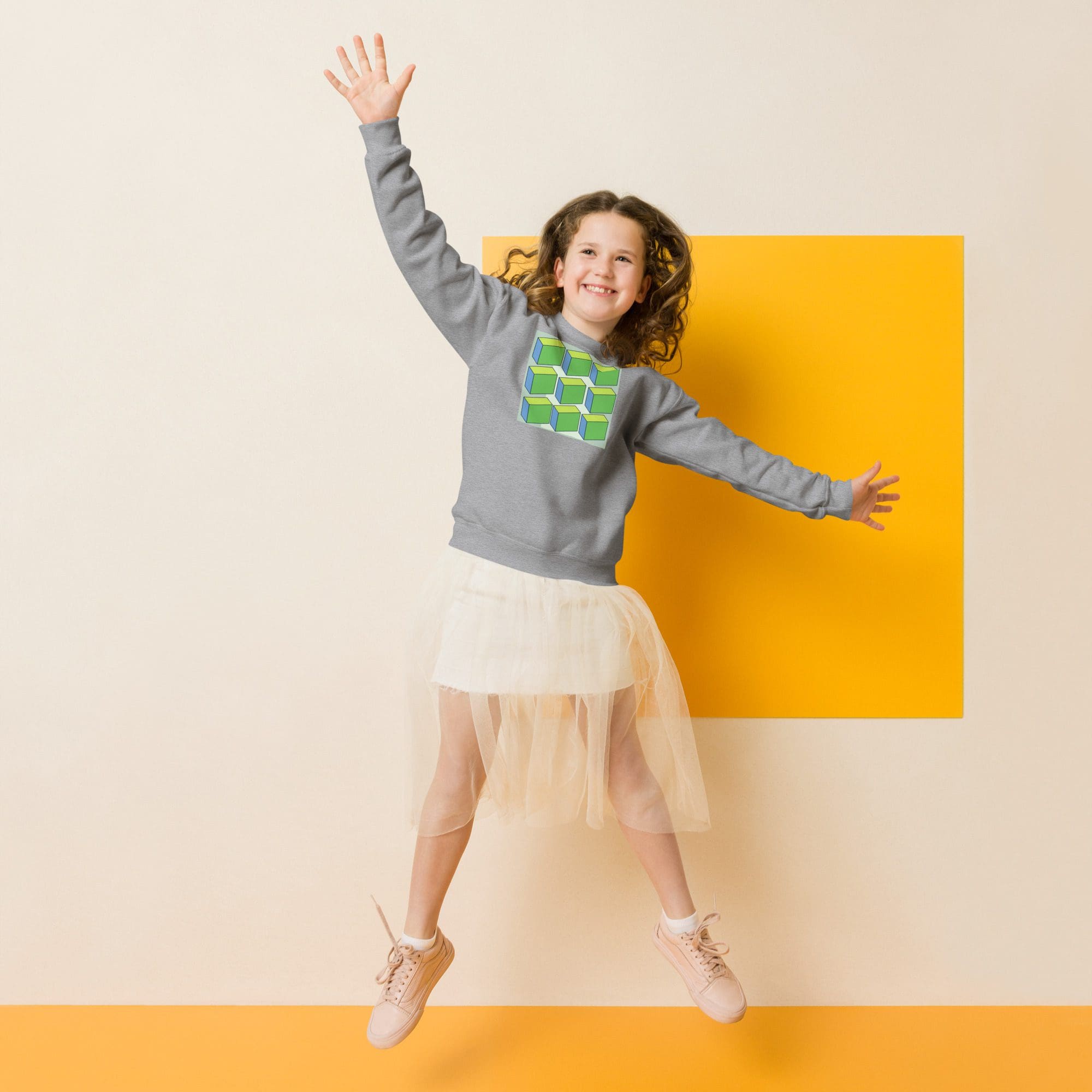 Smiling girl jumping against yellow square backdrop
