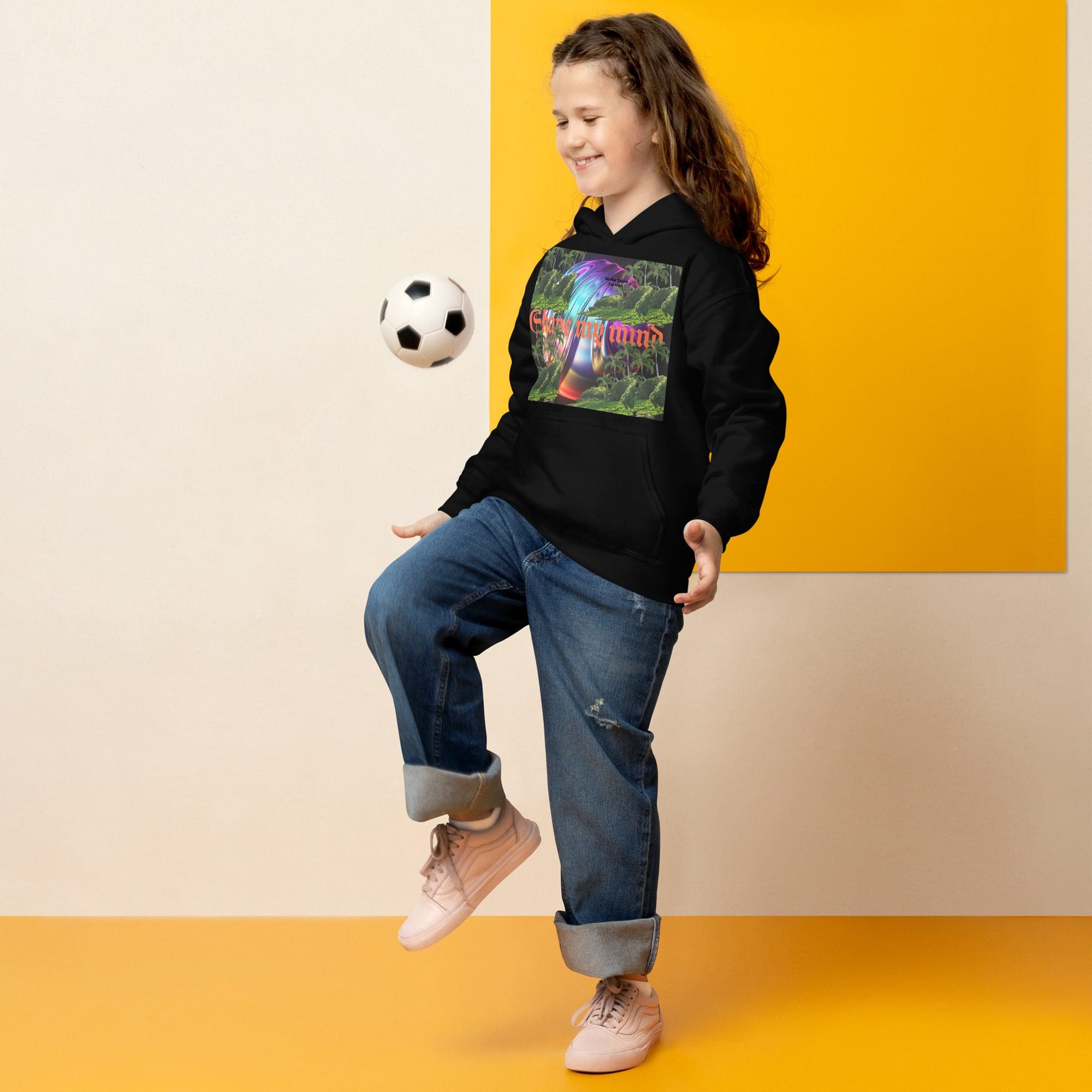 Girl smiling while balancing a soccer ball.
