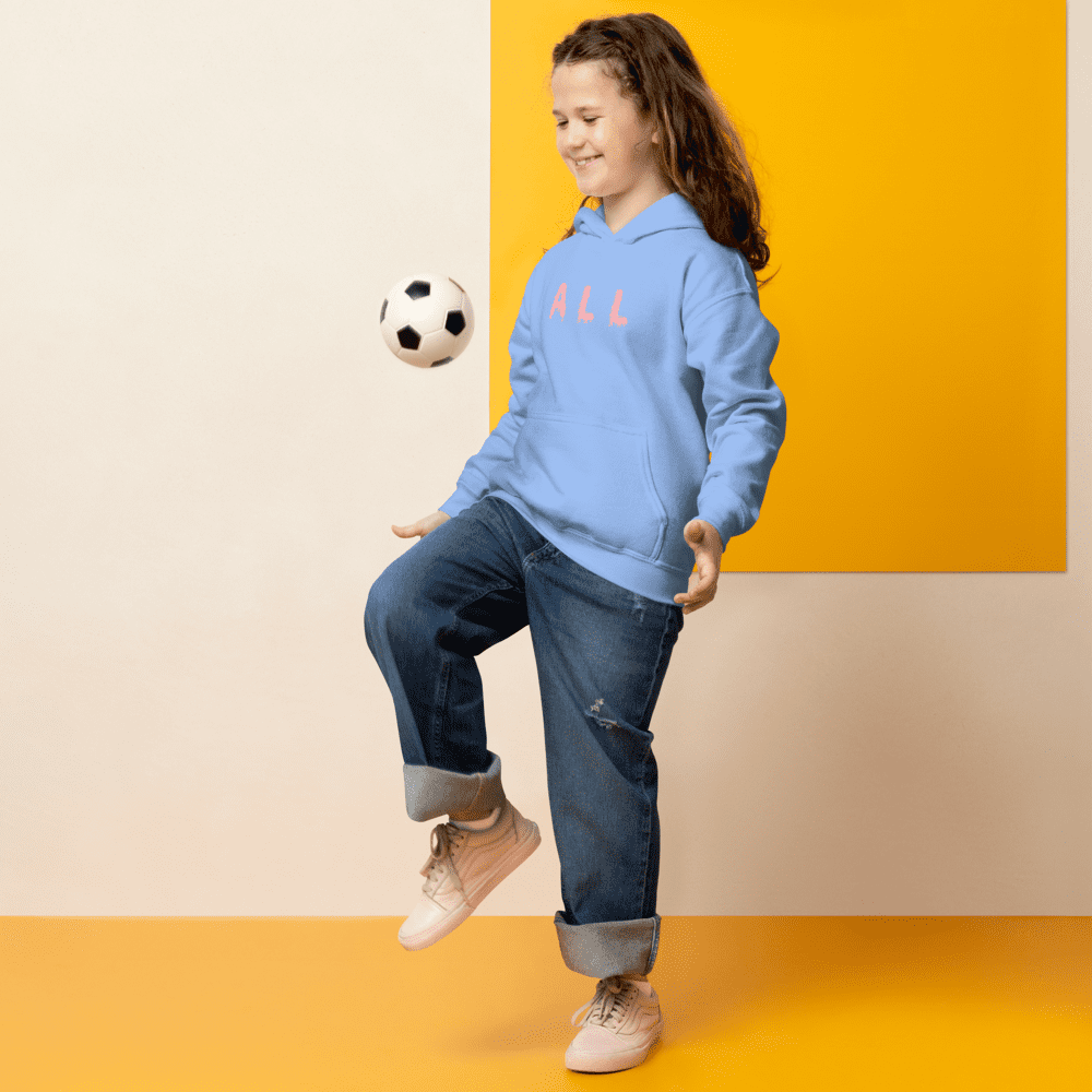 Girl playing soccer with a ball indoors.