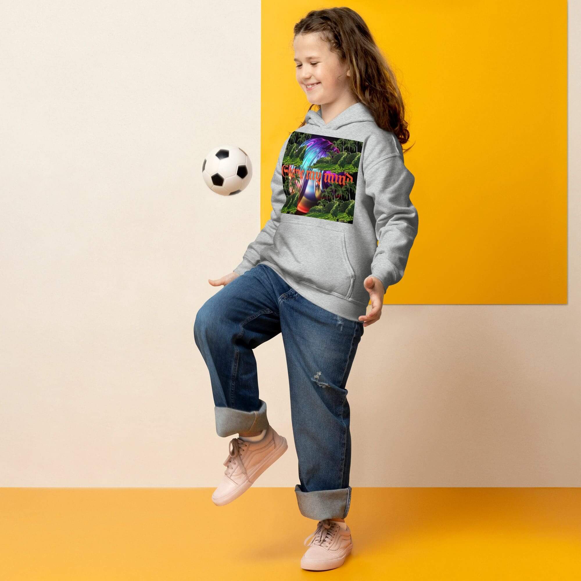 Girl balancing soccer ball in casual outfit.