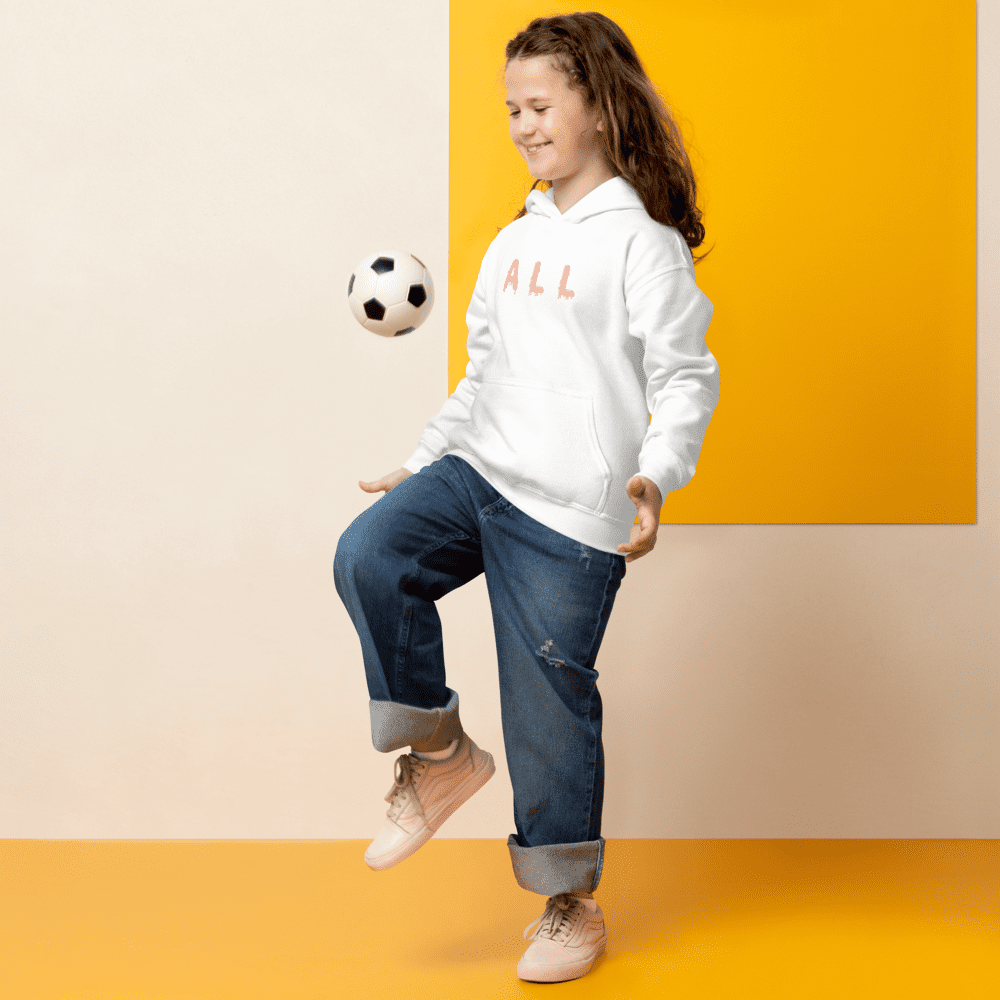 Girl playing with a soccer ball indoors.