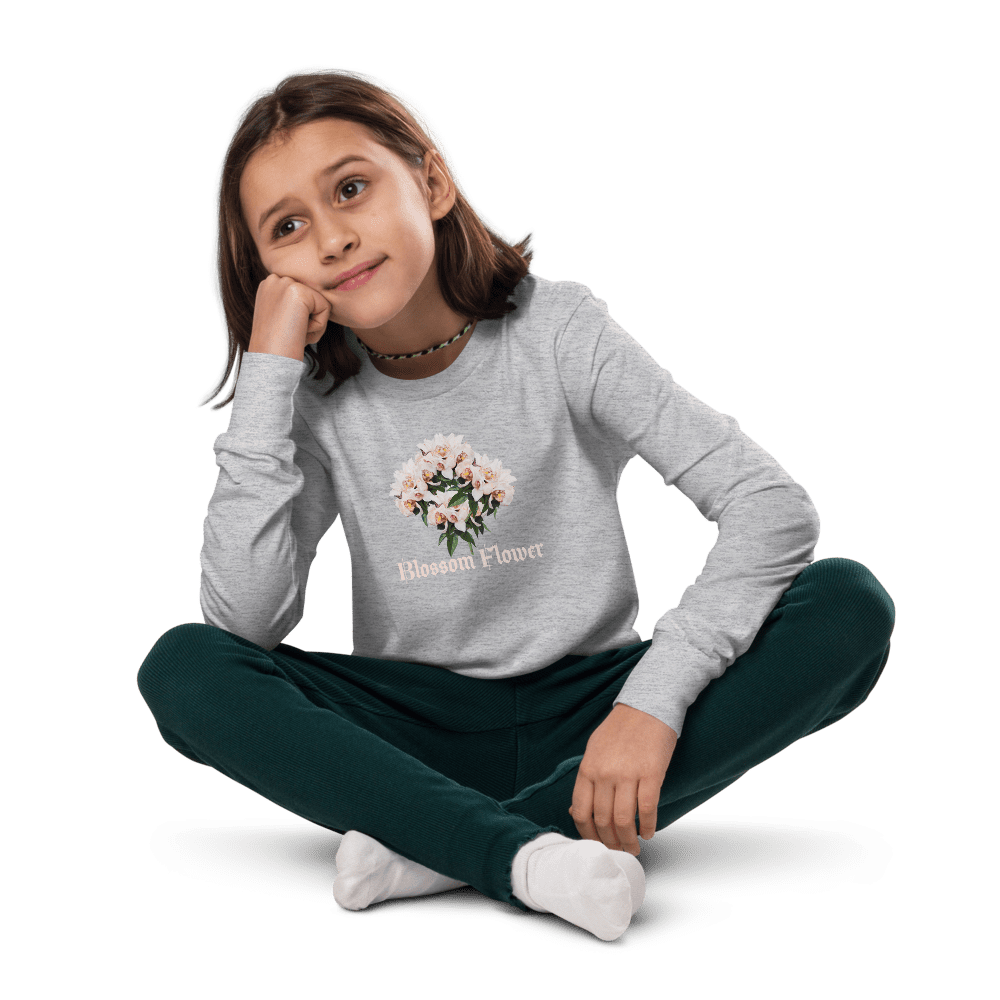 Girl sitting cross-legged, wearing floral sweatshirt.