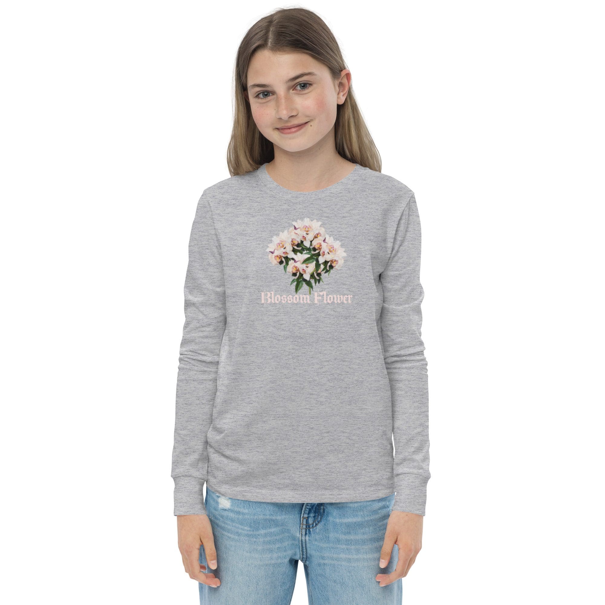 Girl wearing gray floral sweatshirt, smiling.