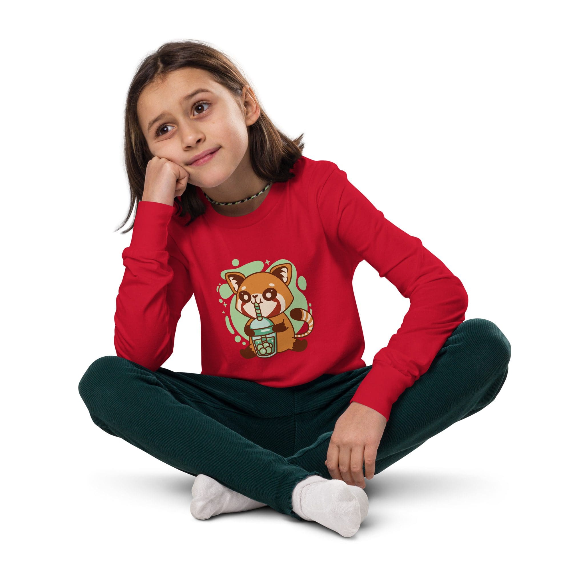Child in red sweater, sitting cross-legged.