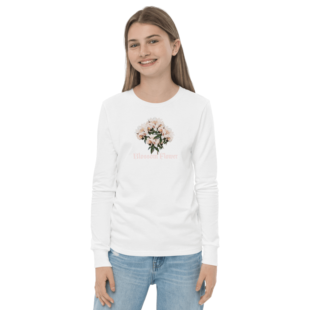 Woman in floral shirt and jeans smiling.