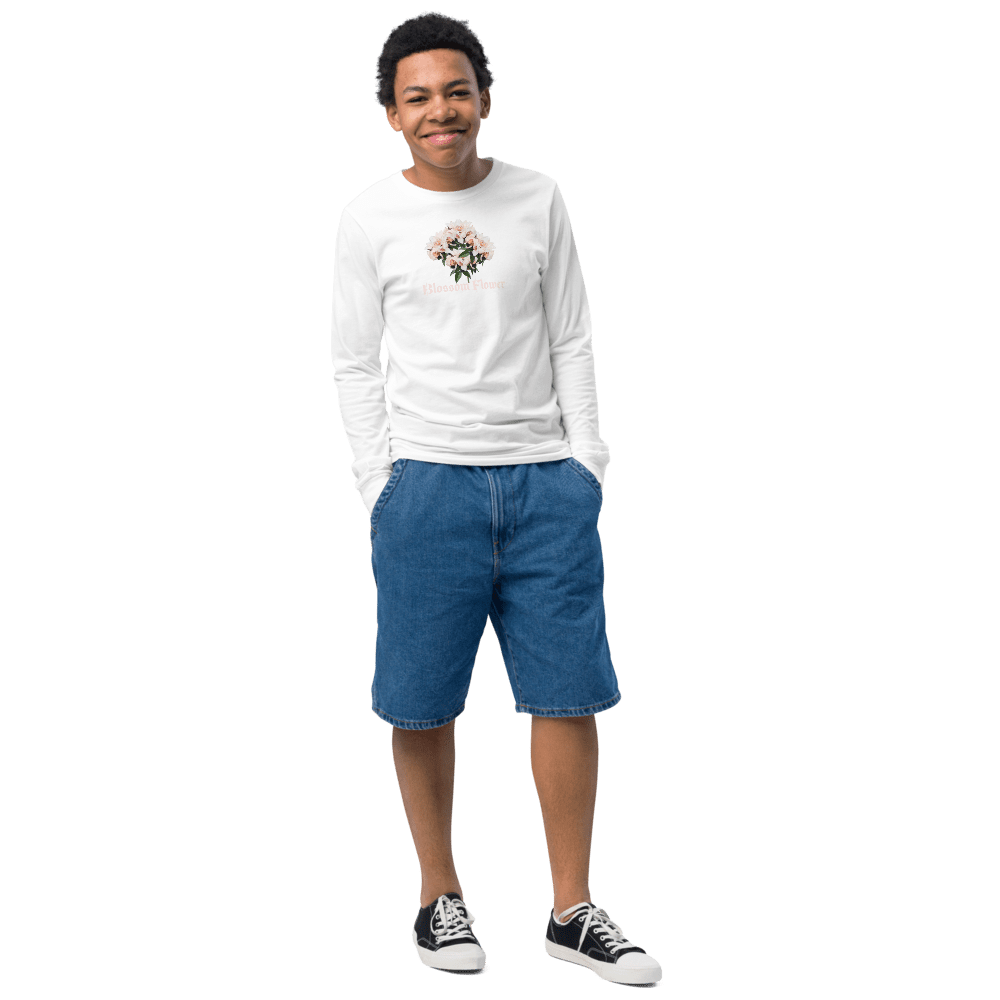 Smiling person in casual outfit, black background.