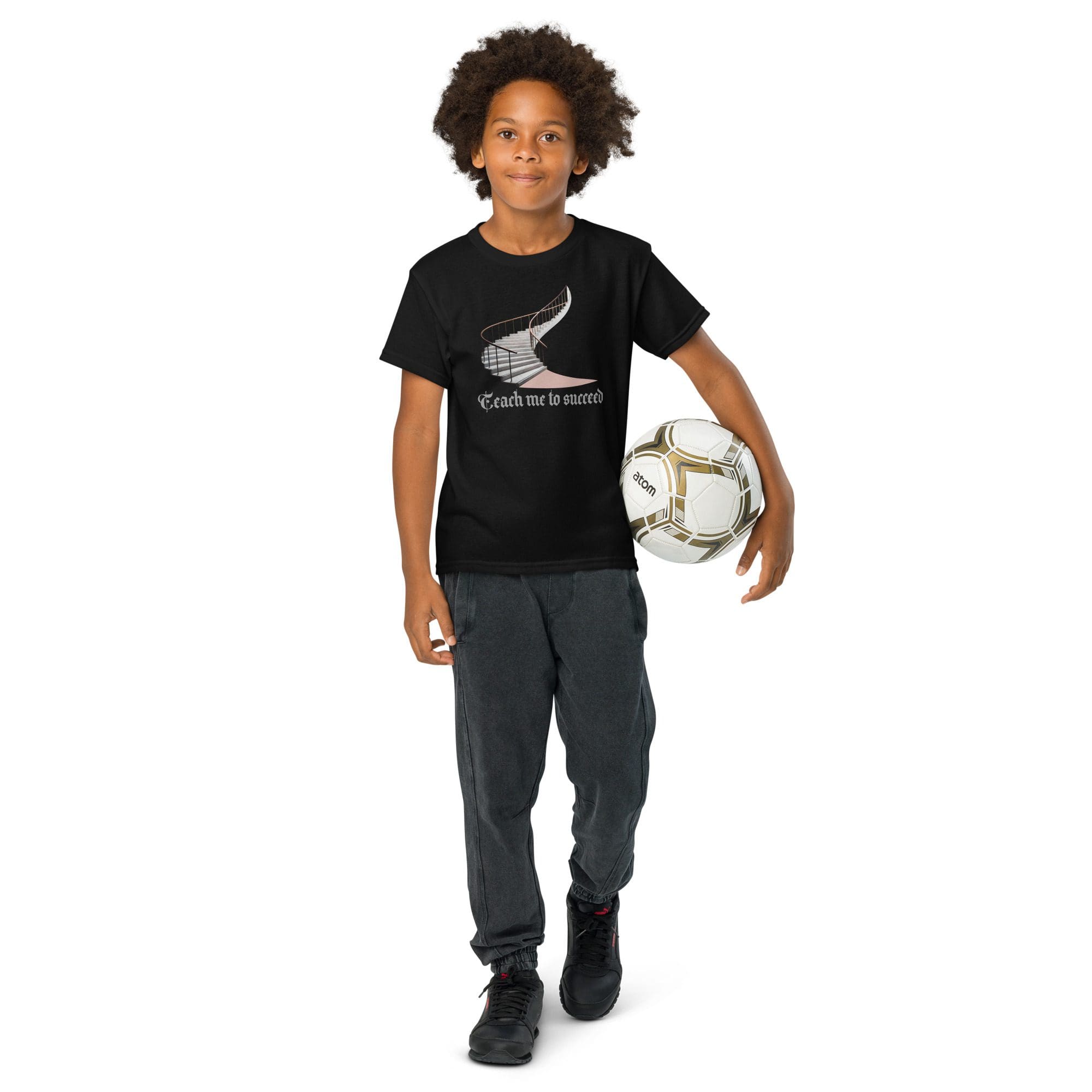 Boy holding soccer ball, wearing black shirt.