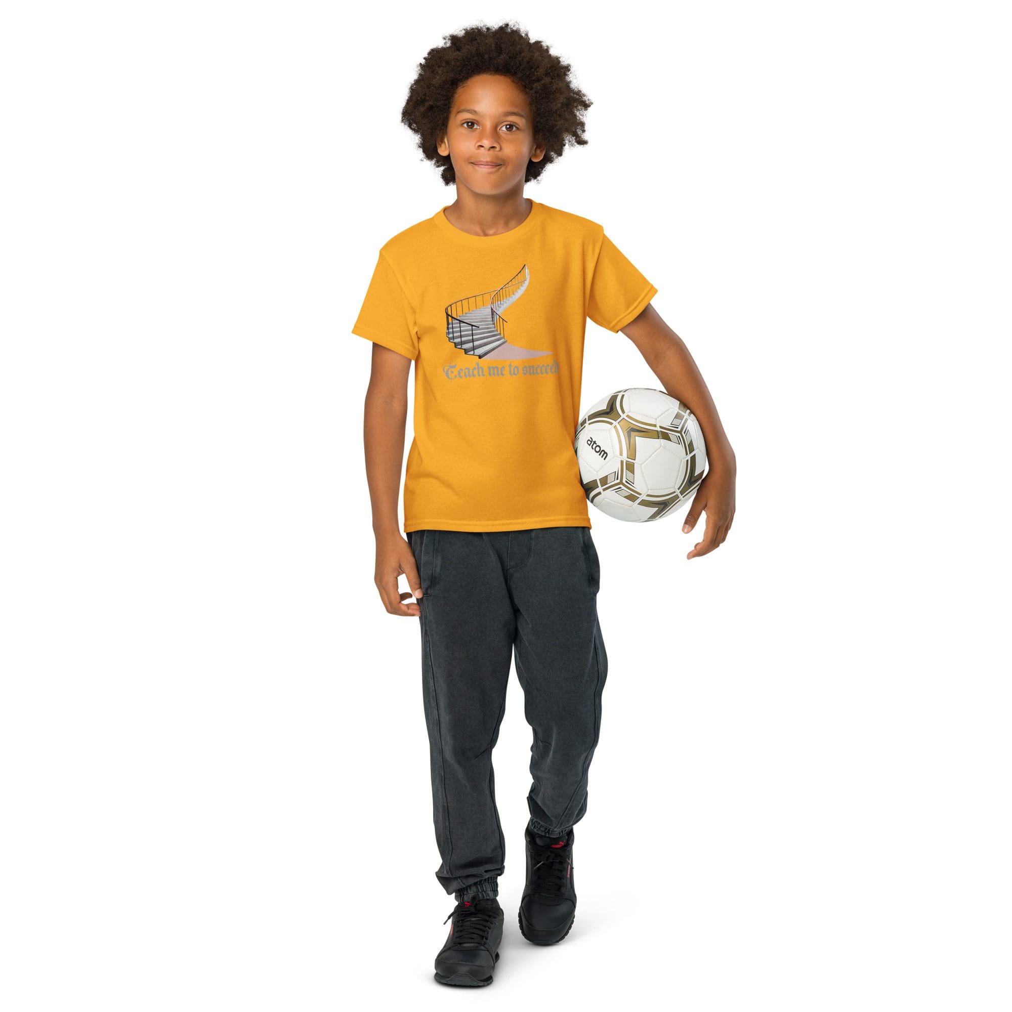 Child holding soccer ball, wearing yellow shirt.