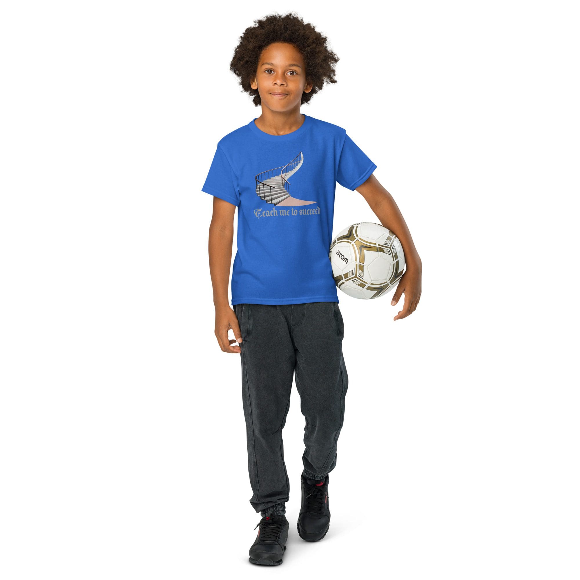 Boy holding a soccer ball, wearing blue shirt.