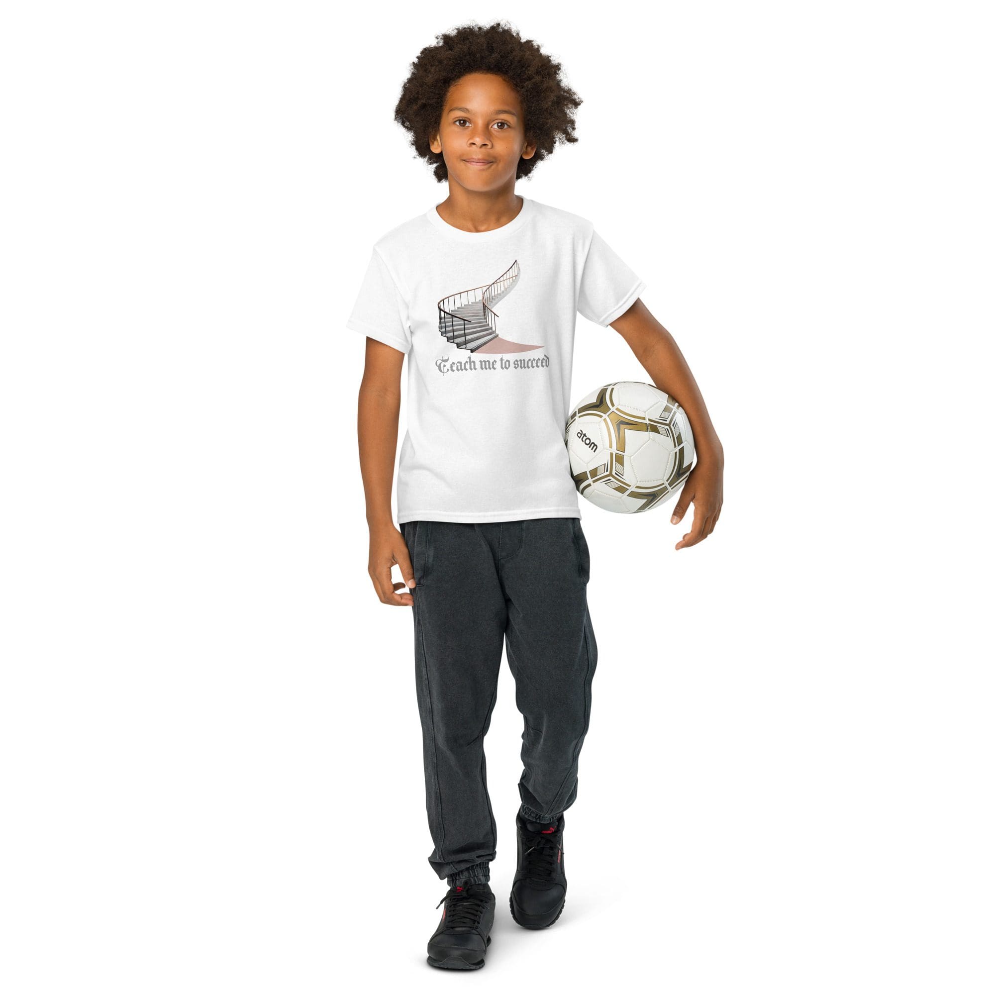 Child holding soccer ball, wearing casual clothes.