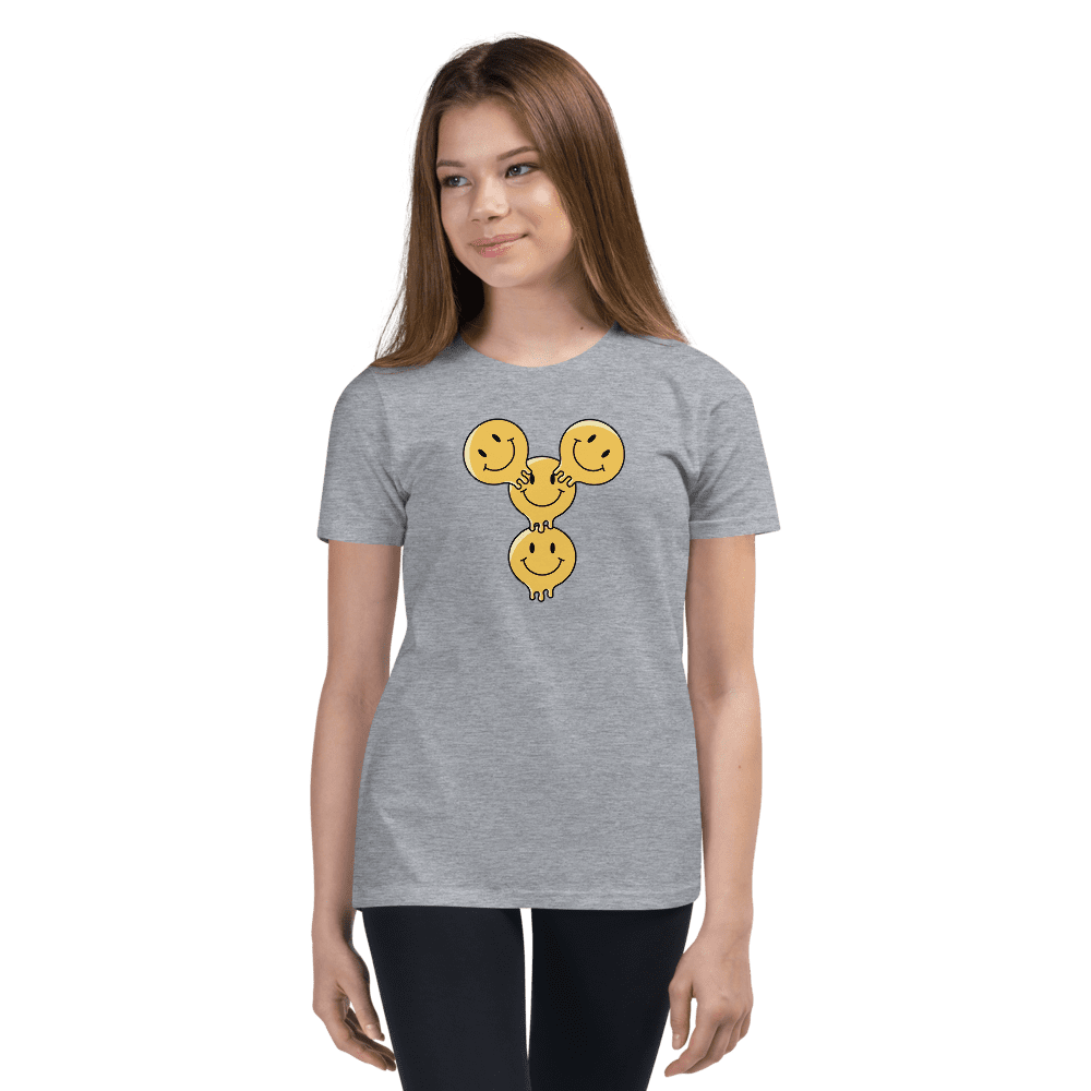 Woman wearing gray T-shirt with smiley design.