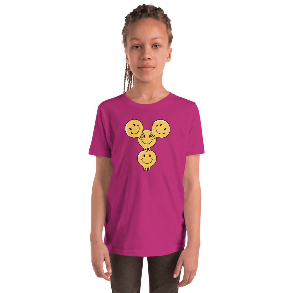 Child in pink shirt with smiley faces.