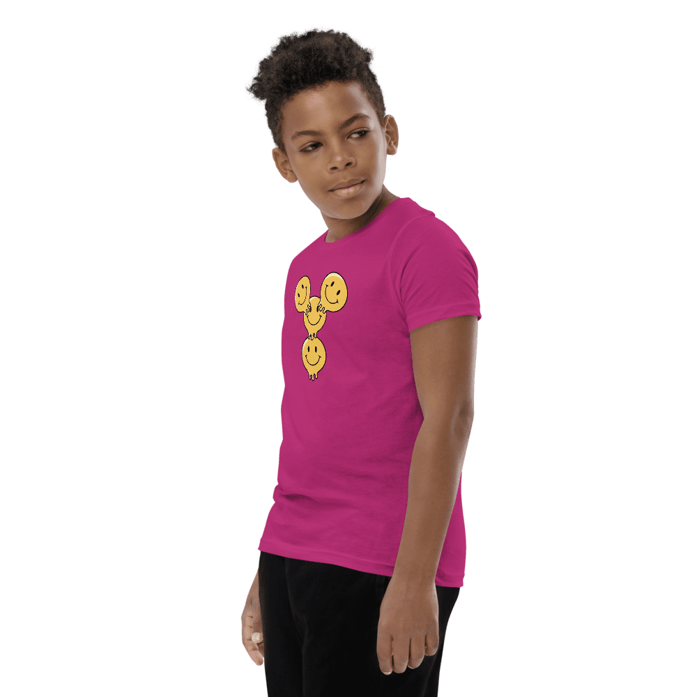 Boy in pink shirt with smiley faces.