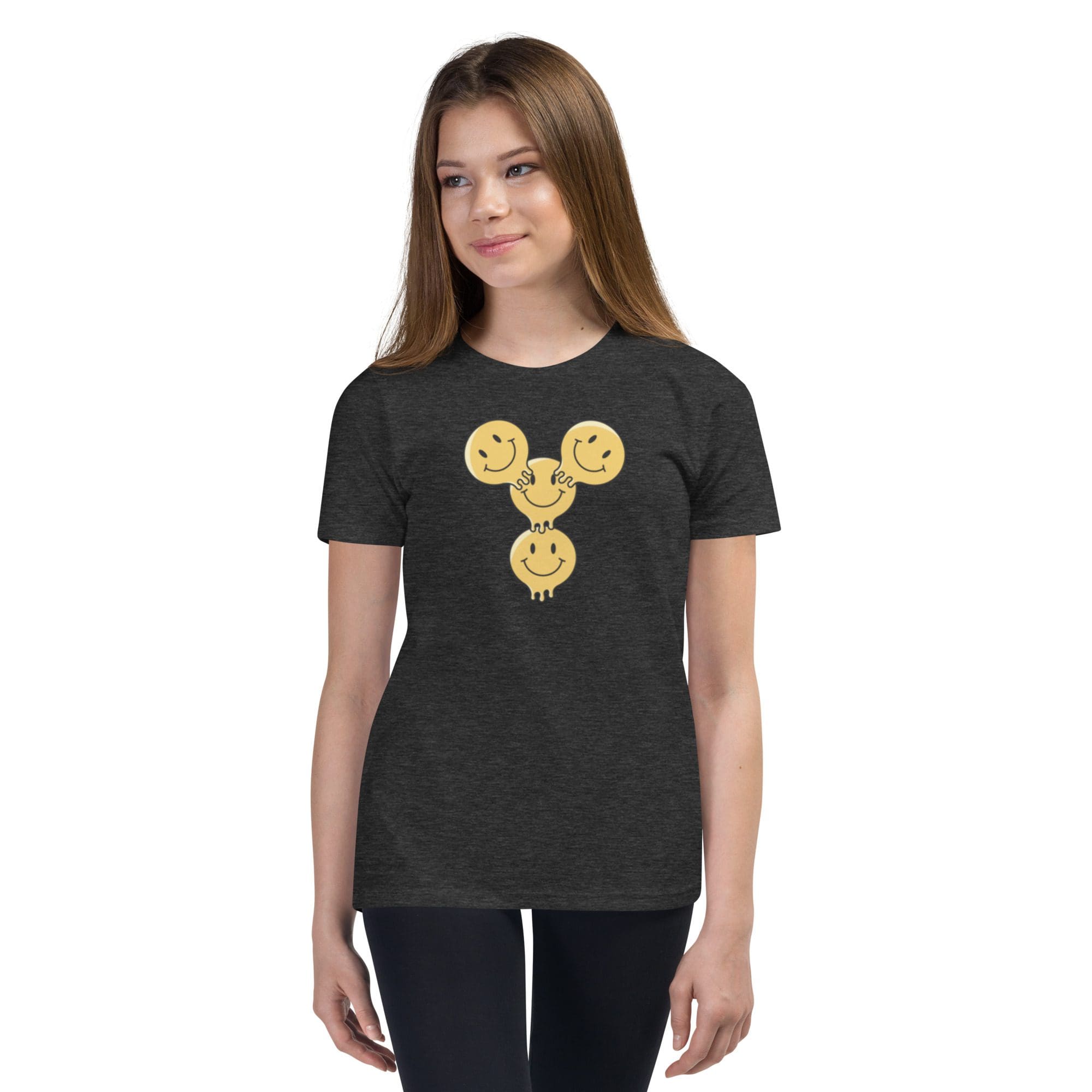 Girl wearing a smiley face t-shirt.